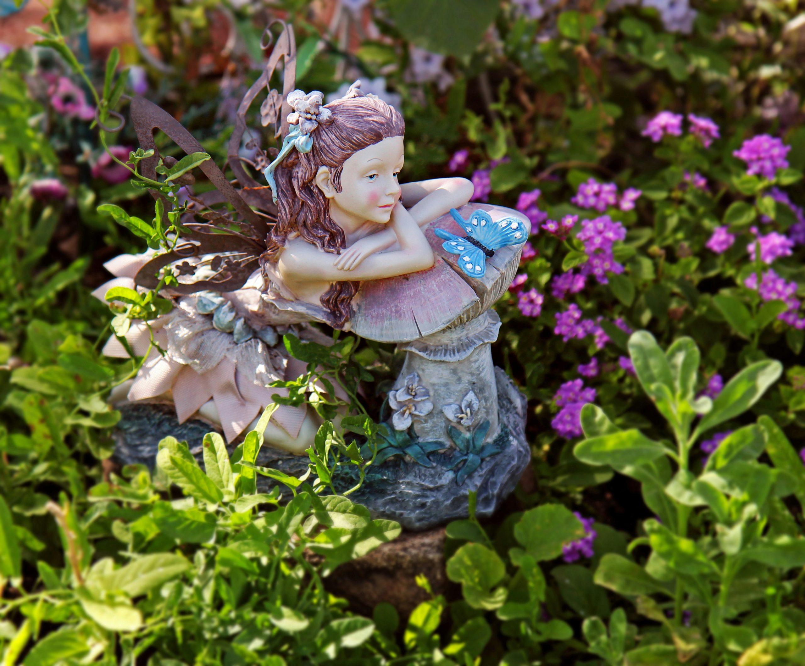 'Fairy Garden' --- A garden fairy surrounded by flowers.