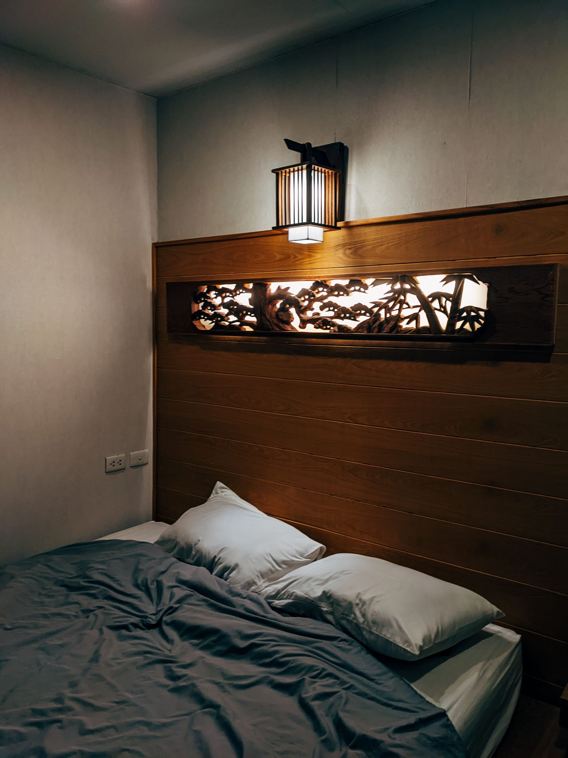 Inviting bedroom scene with soft lighting and elegant wall decor.