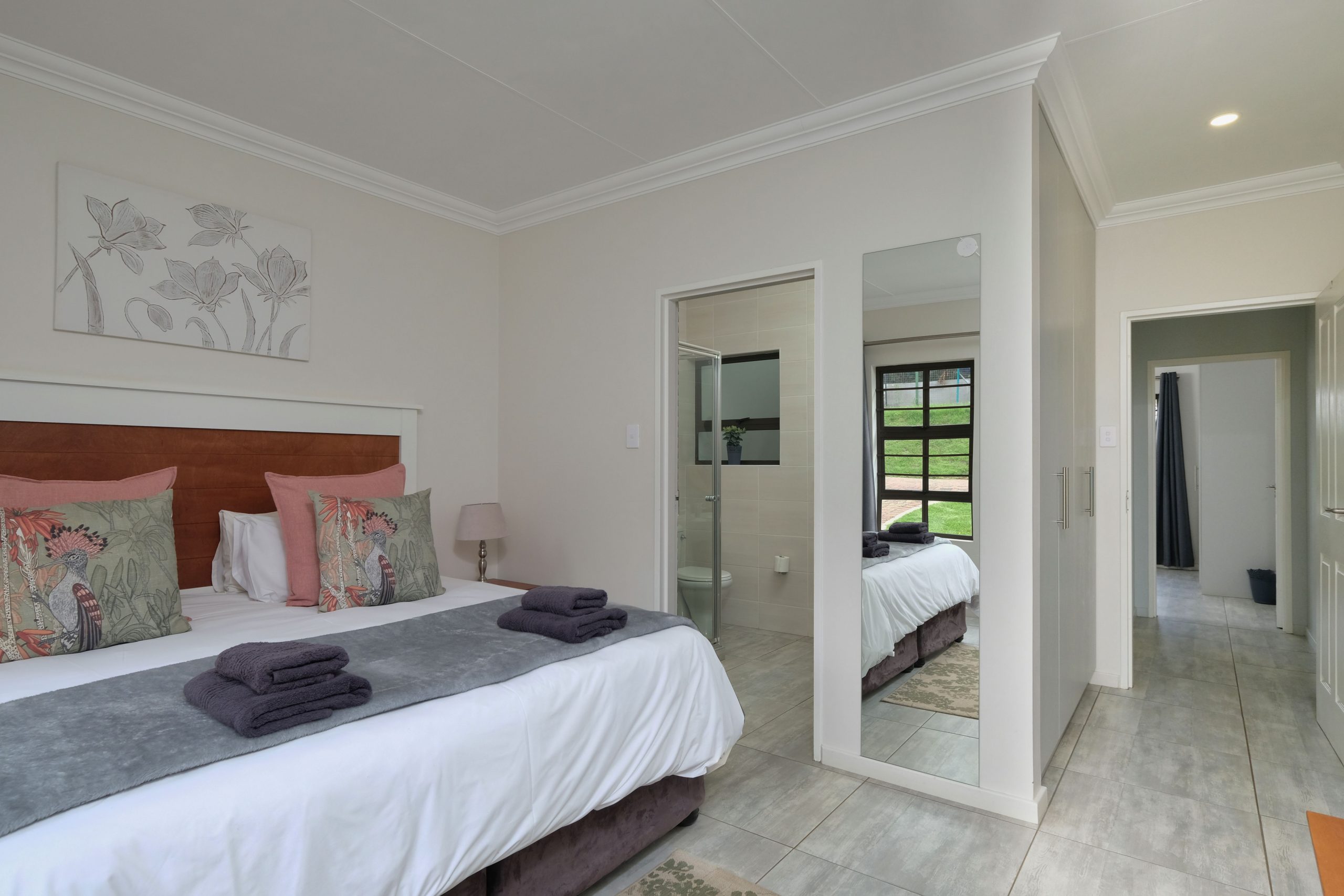 Inviting bedroom with modern decor, large bed, and soft lighting for a cozy atmosphere.