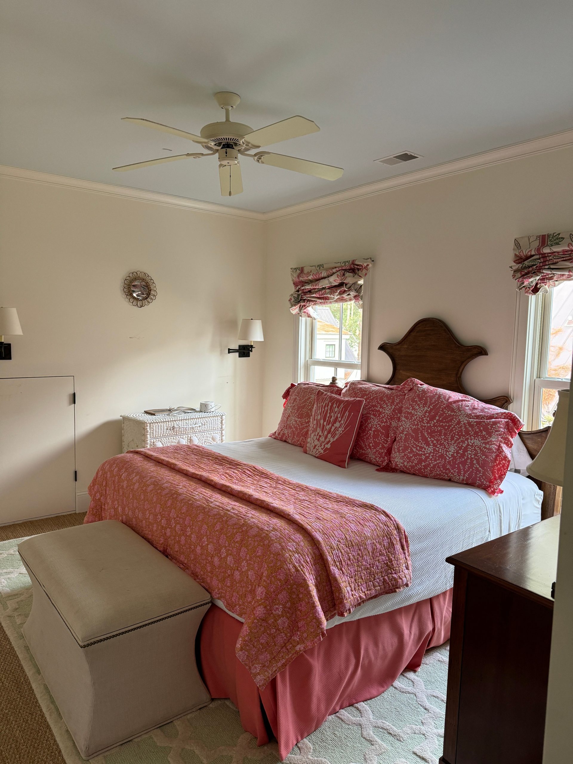 Inviting bedroom with pink bedding and natural light, offering a cozy and serene atmosphere.