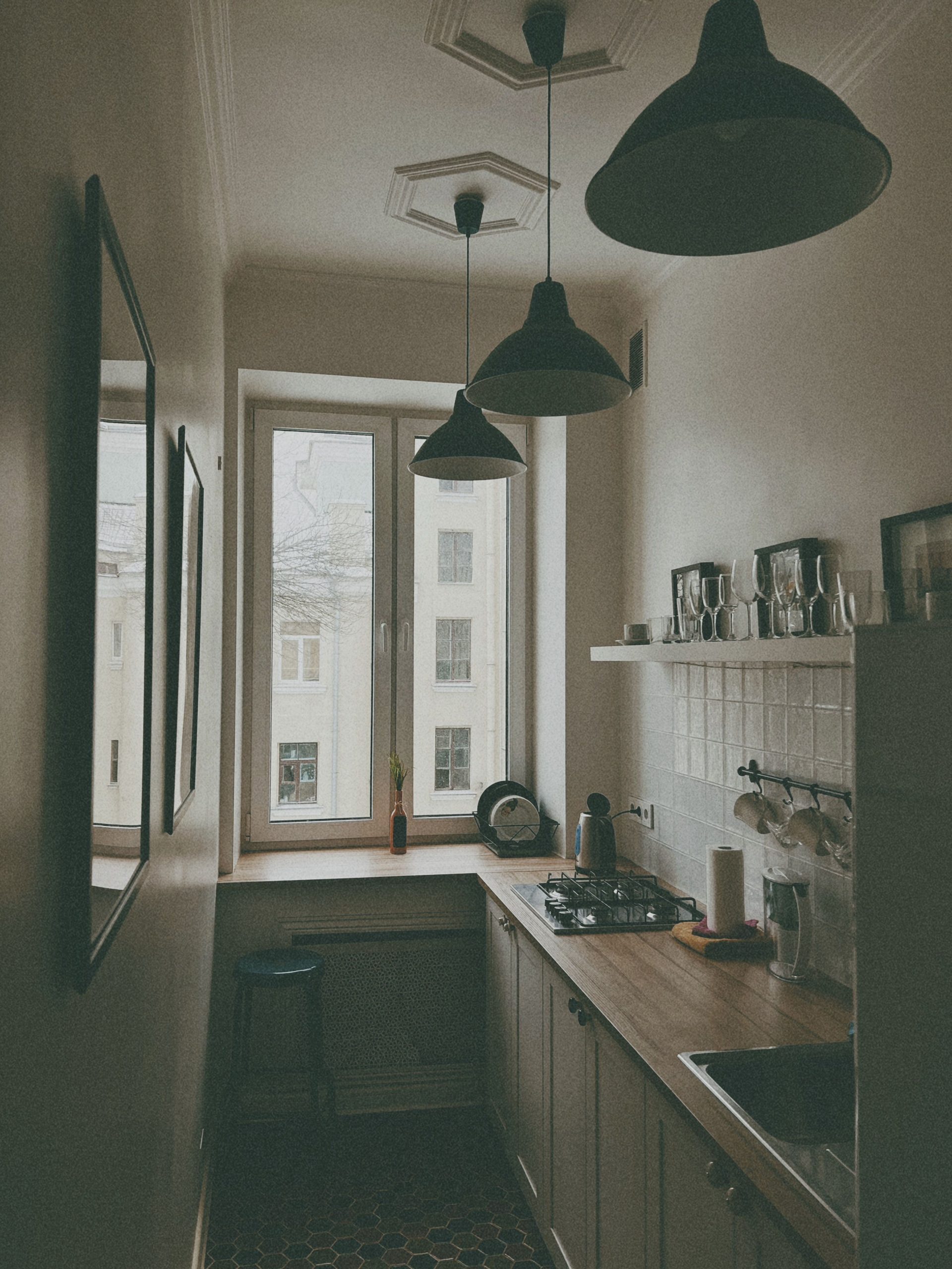 Modern minimalist kitchen interior in Minsk with warm lighting and stylish decor.