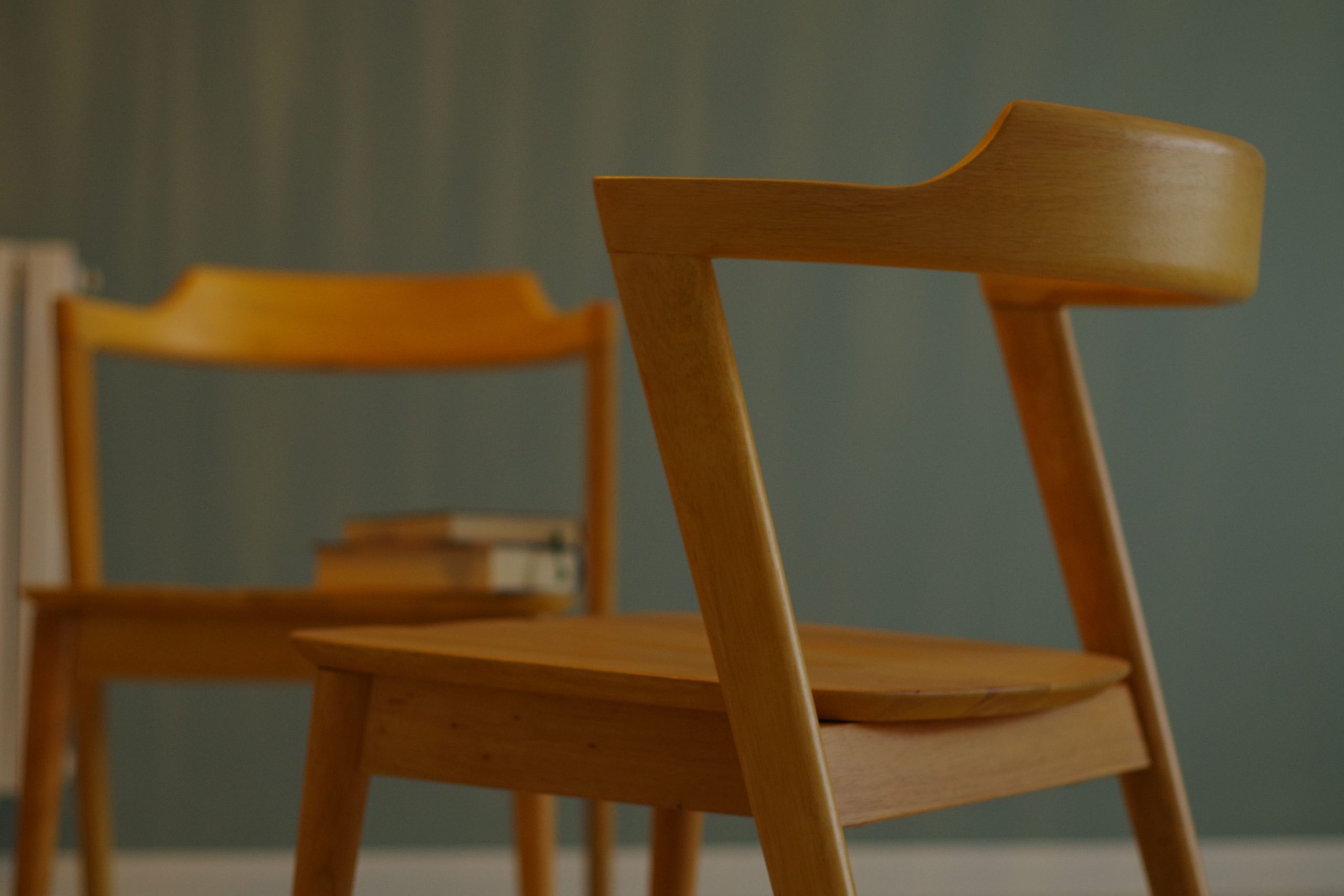 Modern wooden chairs with sleek design in an indoor minimalist setting.