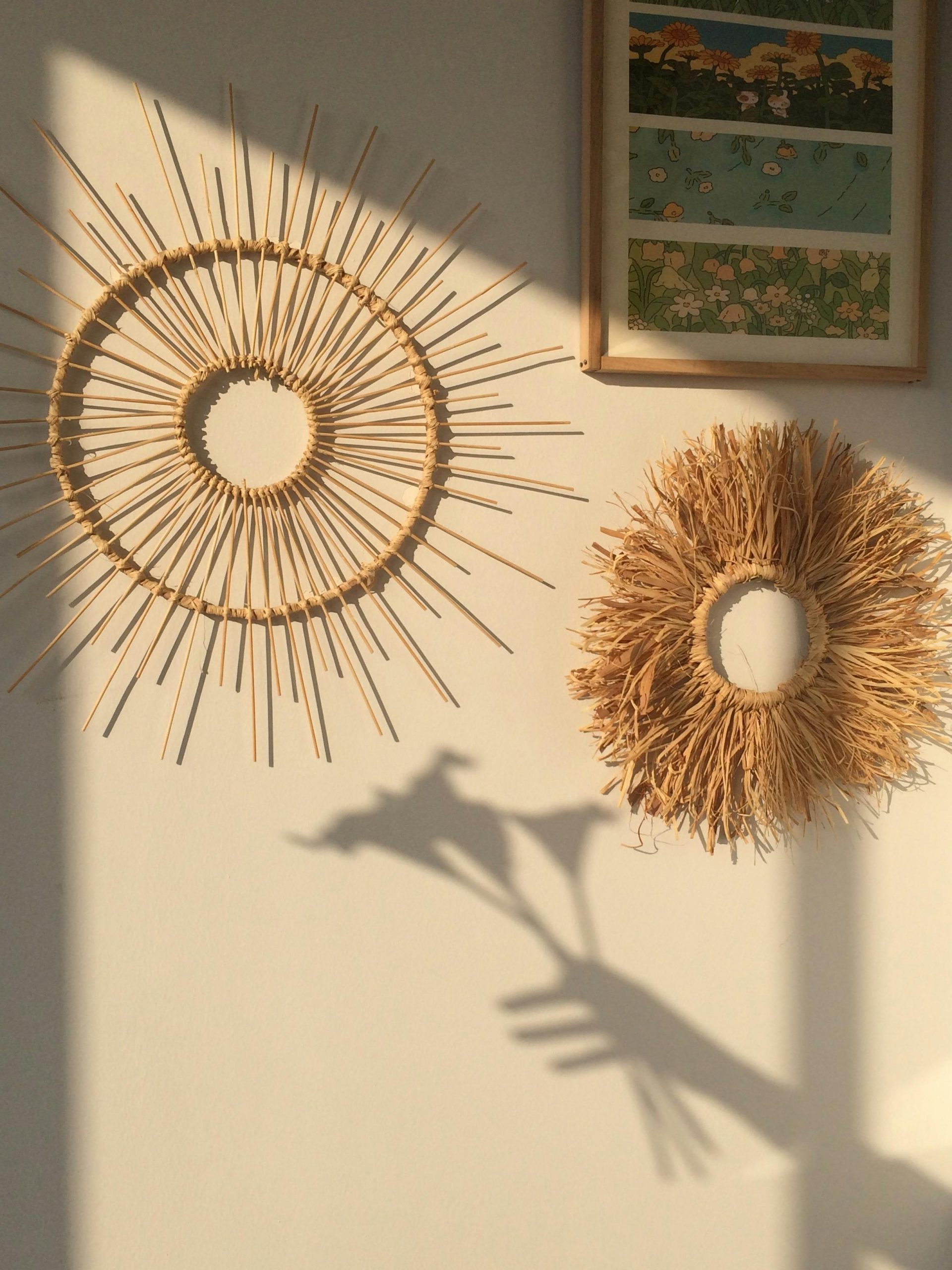 Natural sunburst wall decor casting shadows in warm sunlight.