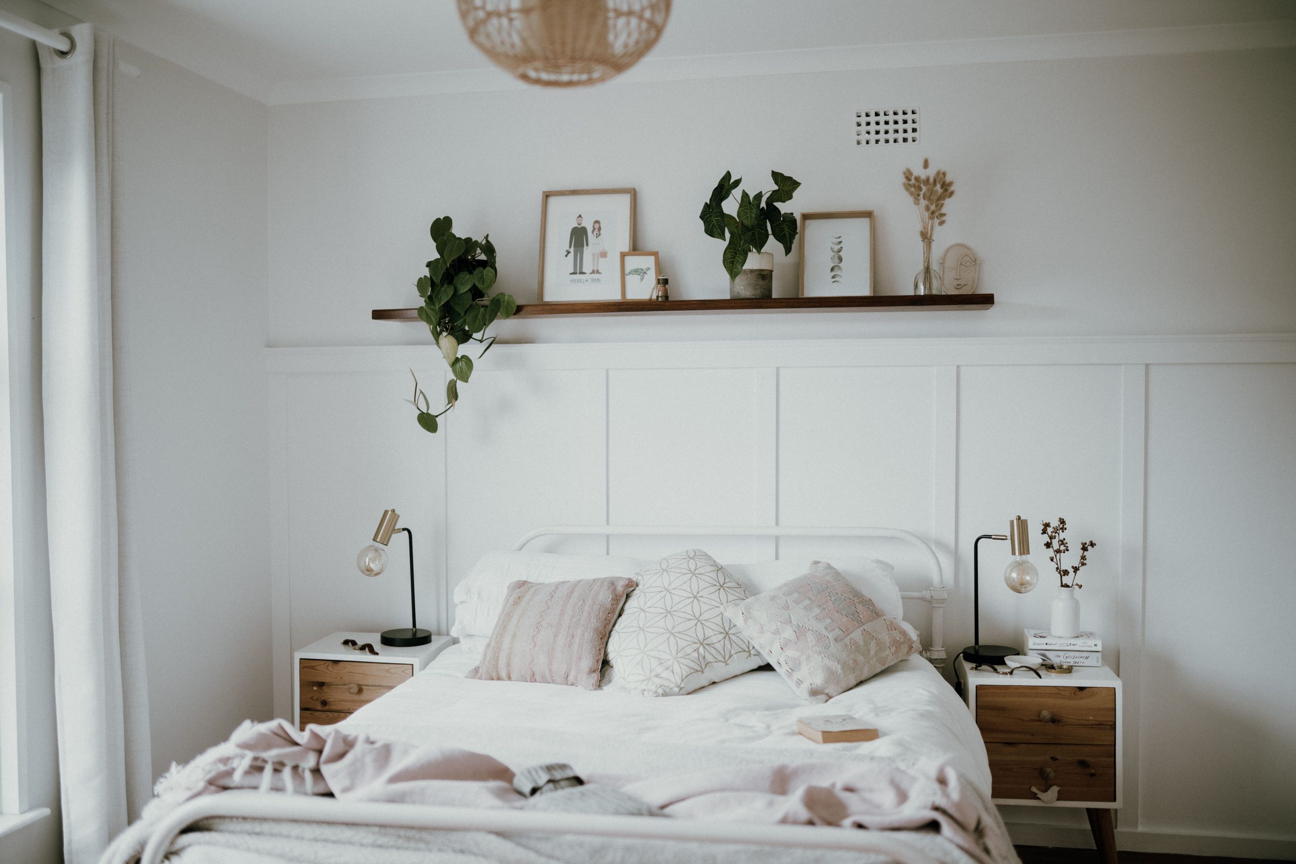 Scandinavian style bedroom featuring minimalist decor, natural light, and indoor plants.