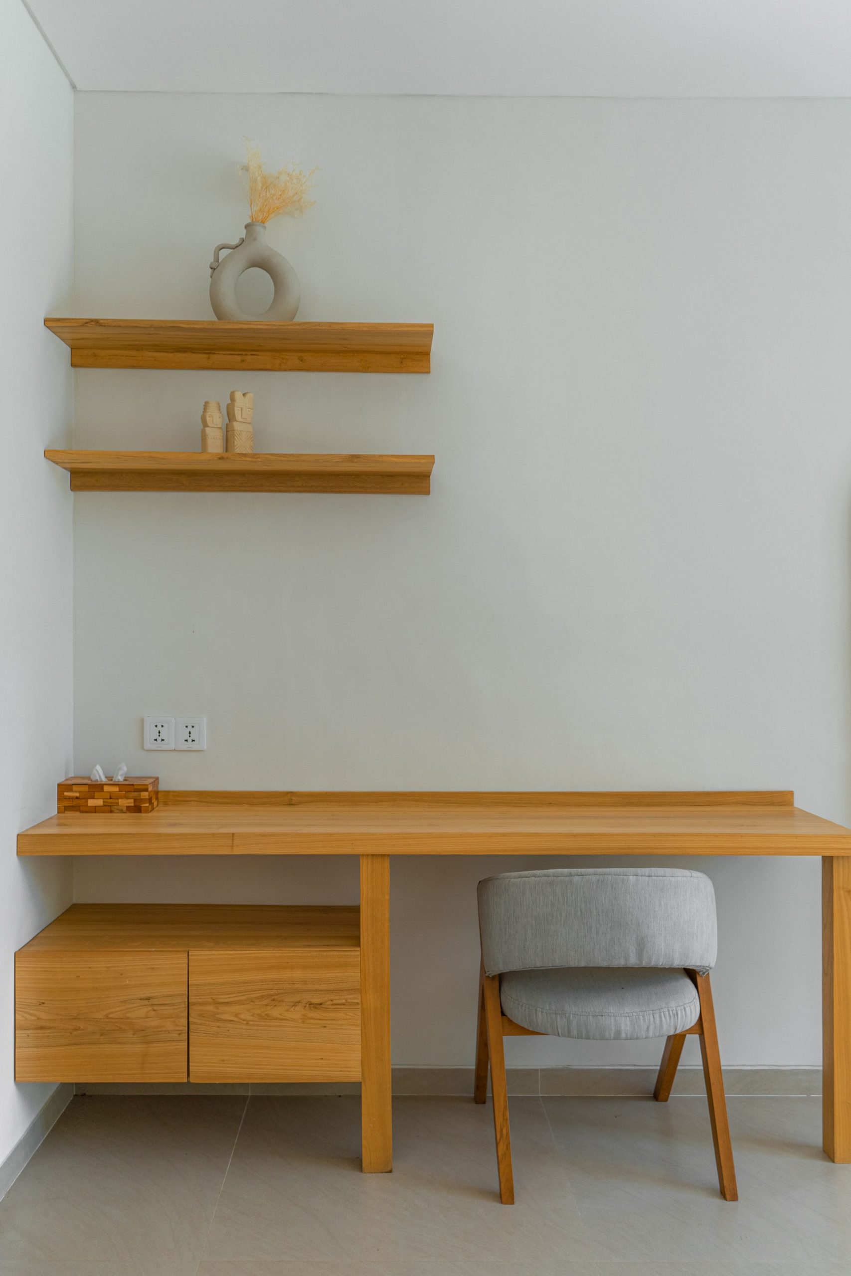 Simple and elegant wooden desk setup in a modern minimalist room.