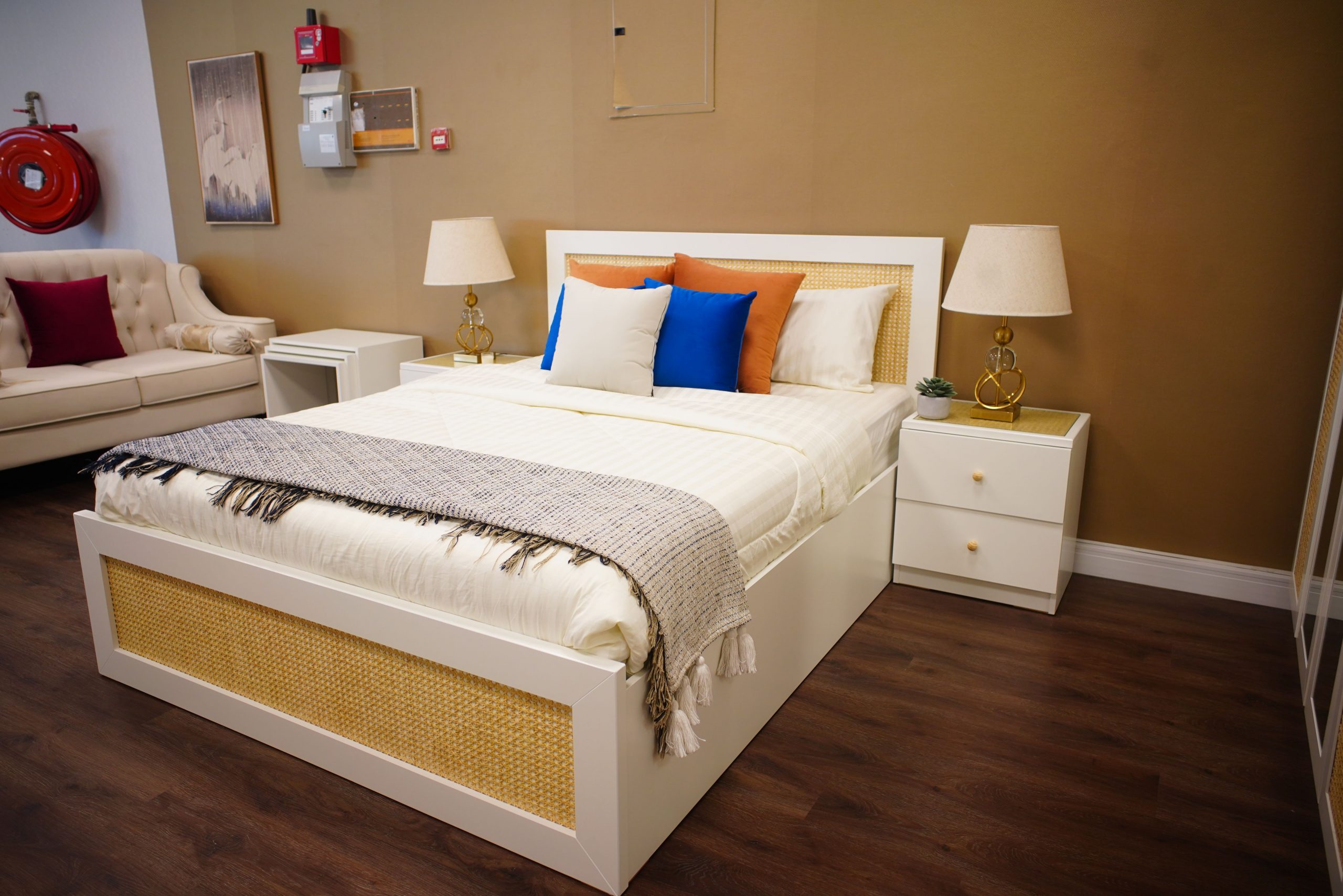 Stylish bedroom featuring a modern bed, cozy sofa, and elegant decor in a warm, minimalistic setting.