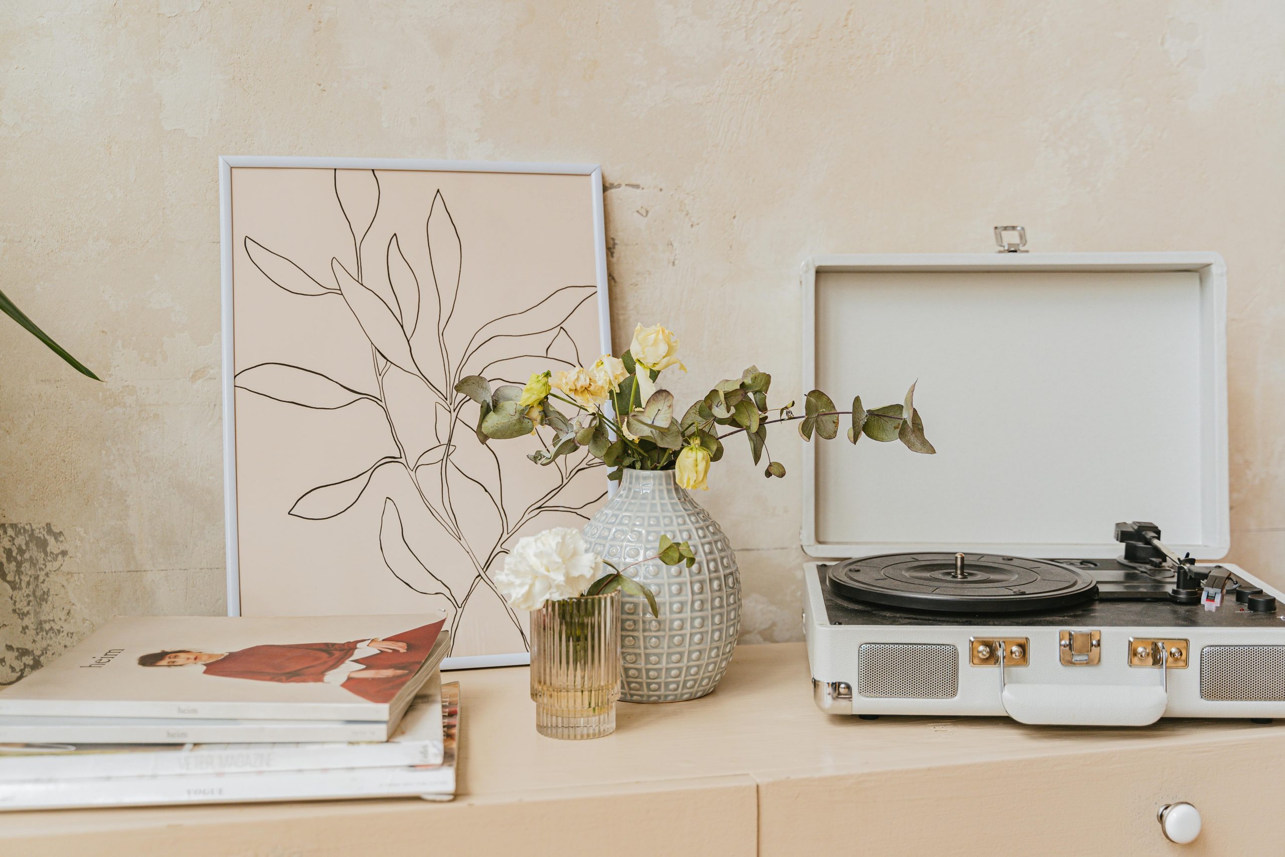 Stylish home interior featuring a gramophone, vase, and minimalist artwork.