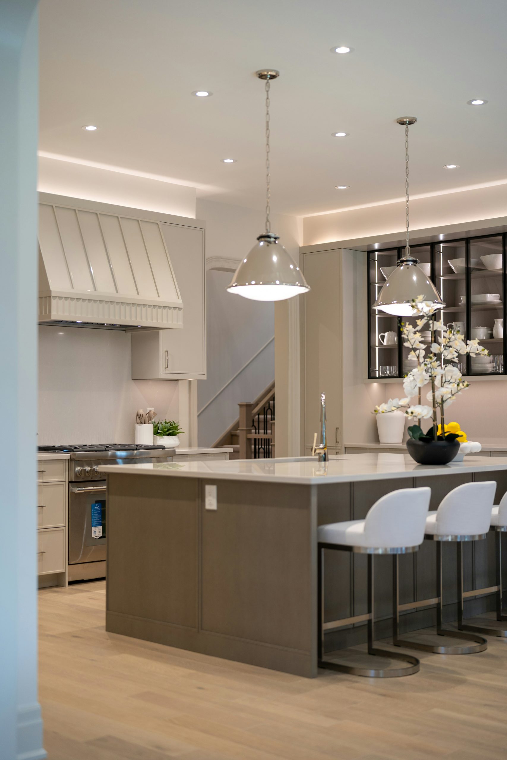Stylish kitchen with island, pendant lights, and bar stools.