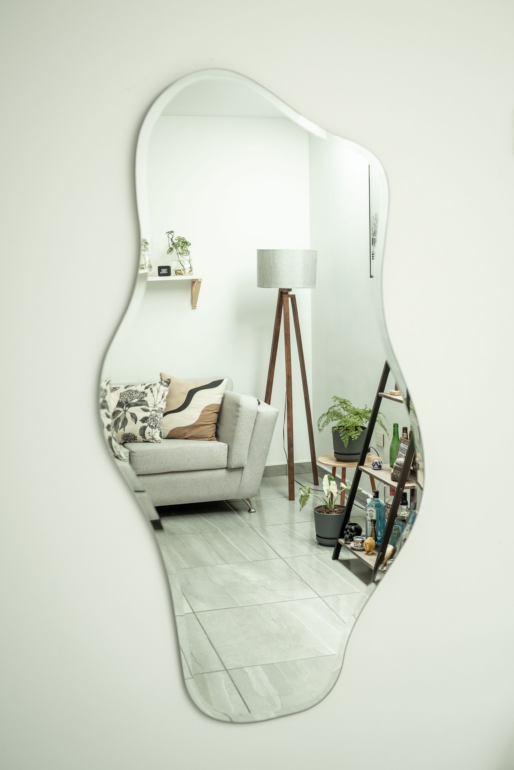 Stylish living room decor reflected in an abstract mirror, showcasing elegant interior design.