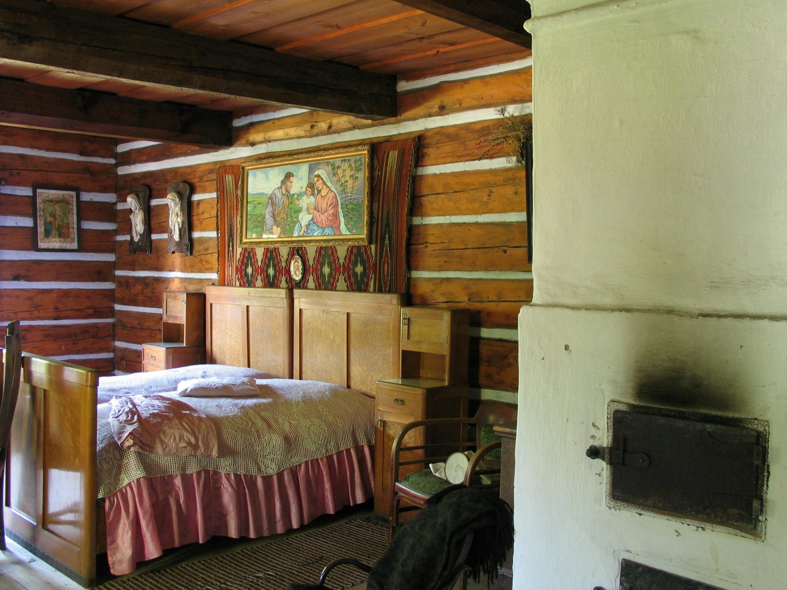 Warm and inviting rustic cabin bedroom with wooden interiors and traditional decor.