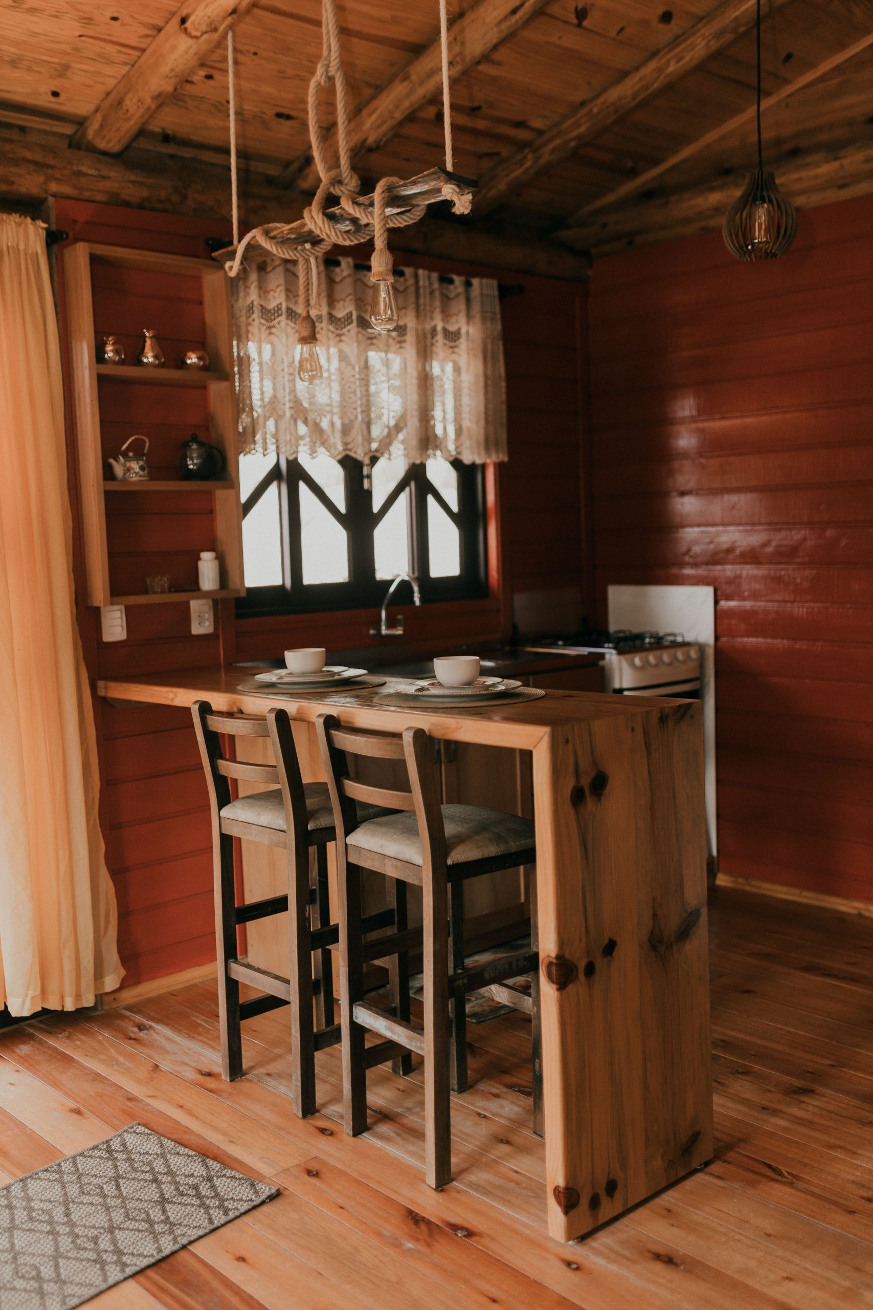 Warm and inviting rustic cabin kitchen interior featuring wooden decor and vintage elements.