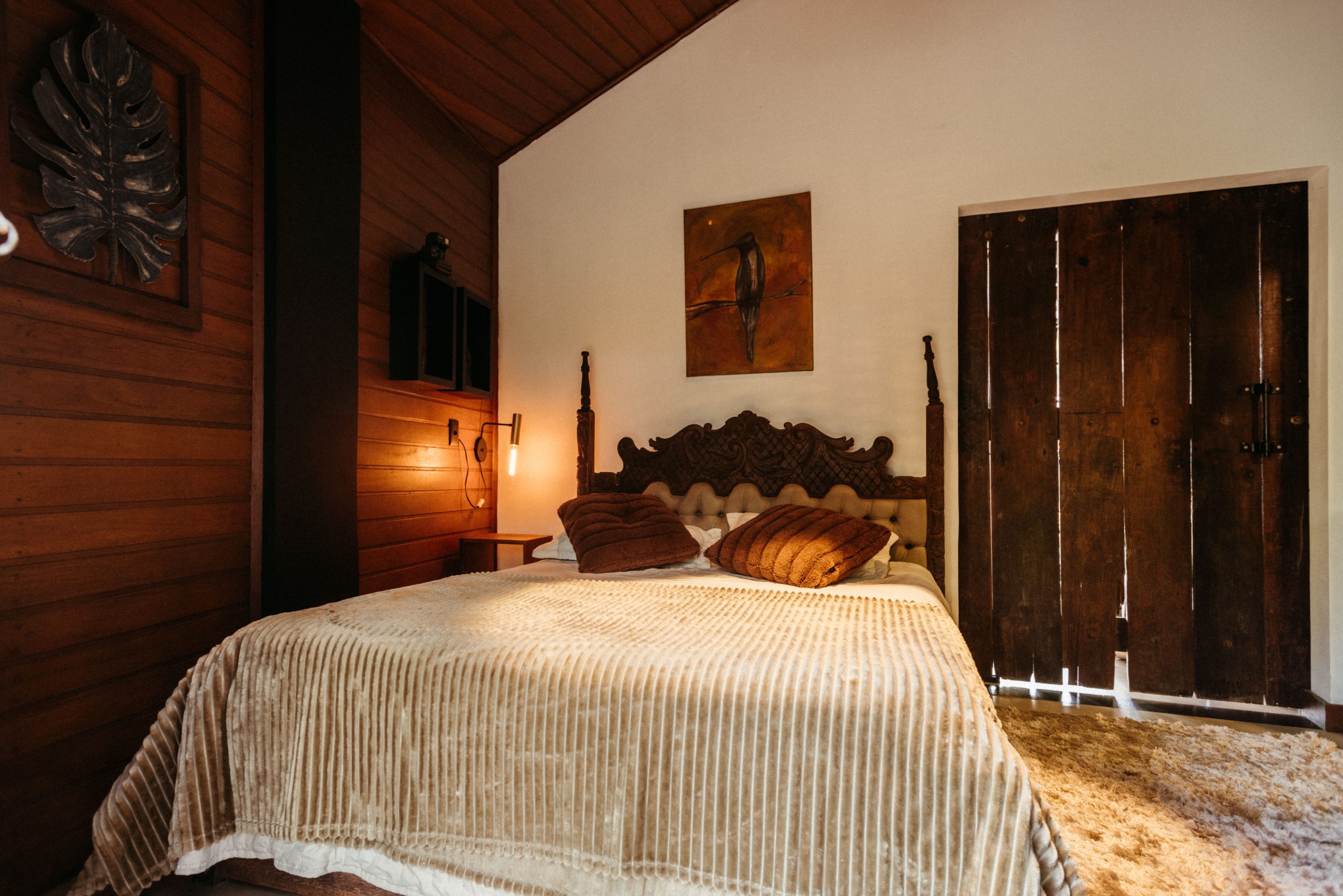 Warm, inviting wooden bedroom interior in Santa Teresa, Brasil.