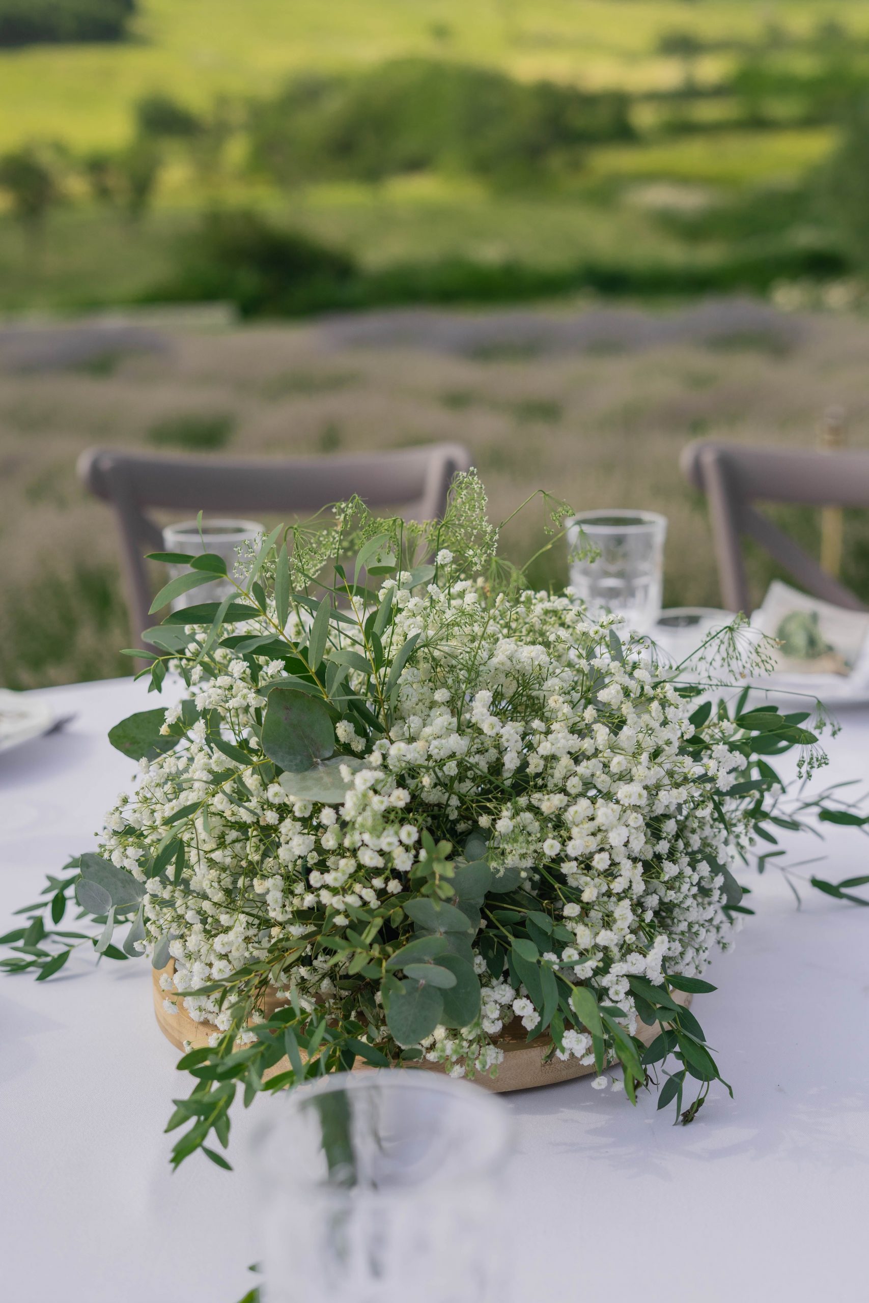 Beautiful outdoor table with white floral centerpiece in Bucharest, Romania.