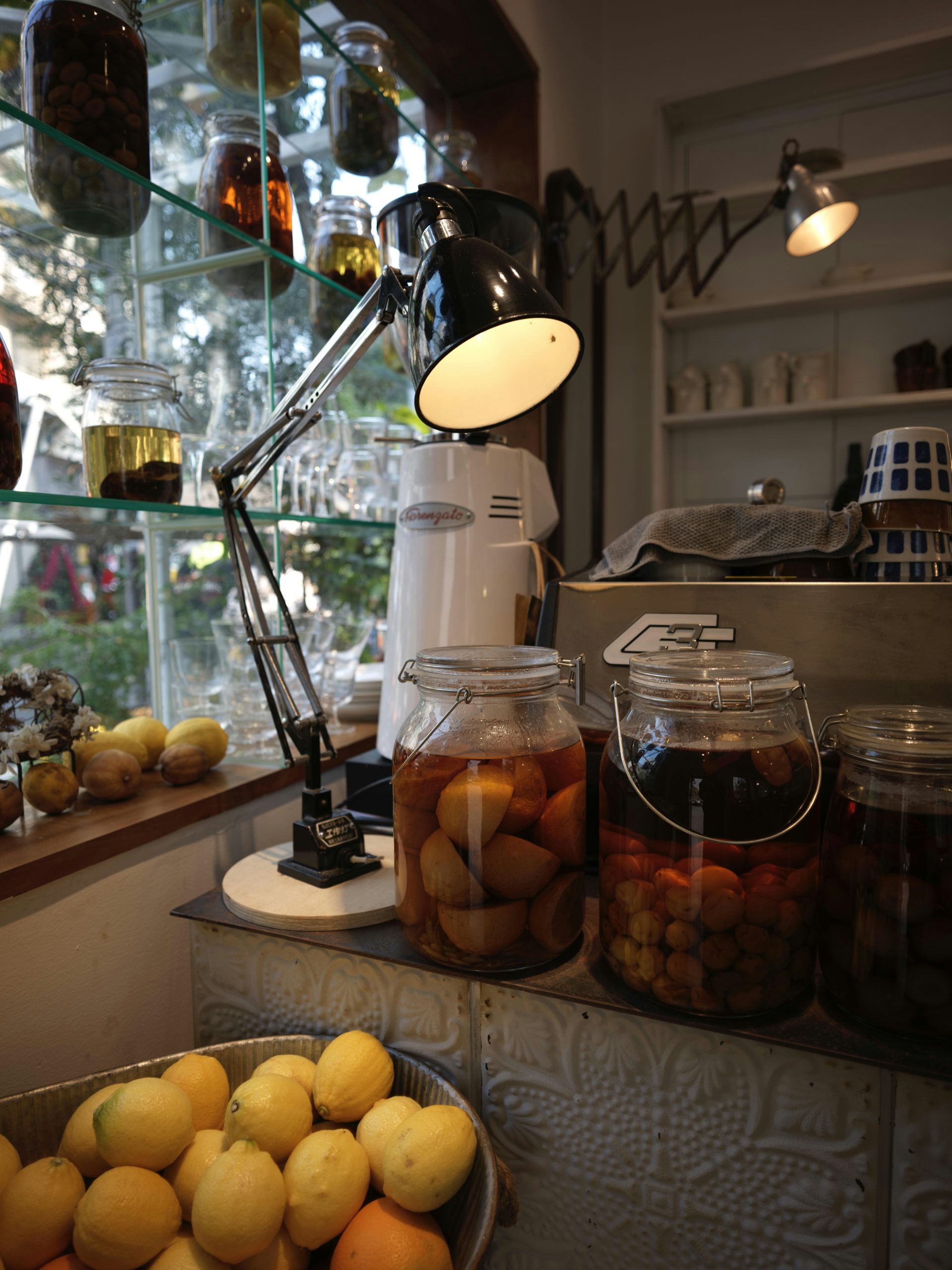 Jars of fruit and preserved goods on a shelf.