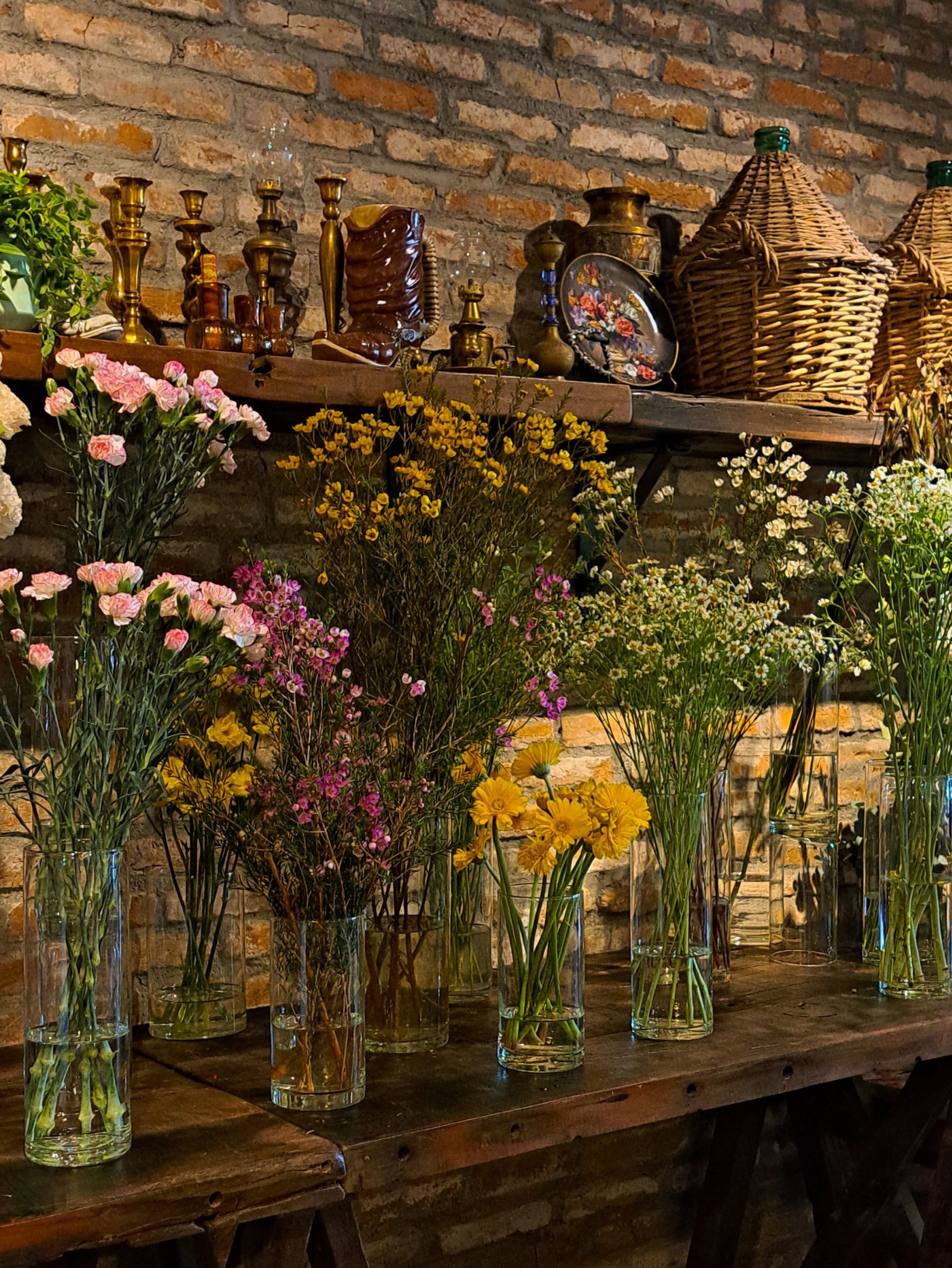 Rustic interior with colorful floral arrangements on a wooden table, perfect for cozy decor themes.