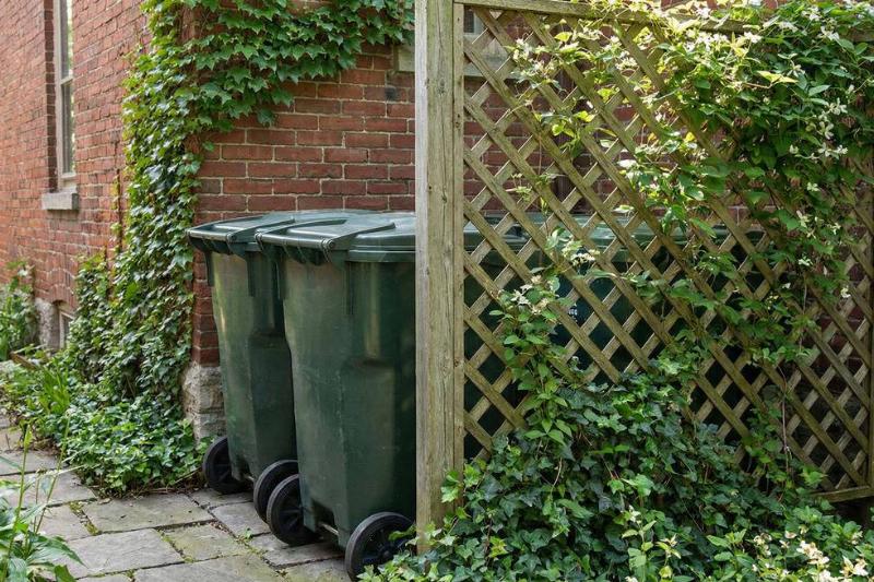 Sick of looking at ugly trash cans? Make them blend in beautifully - ManMadeDIY