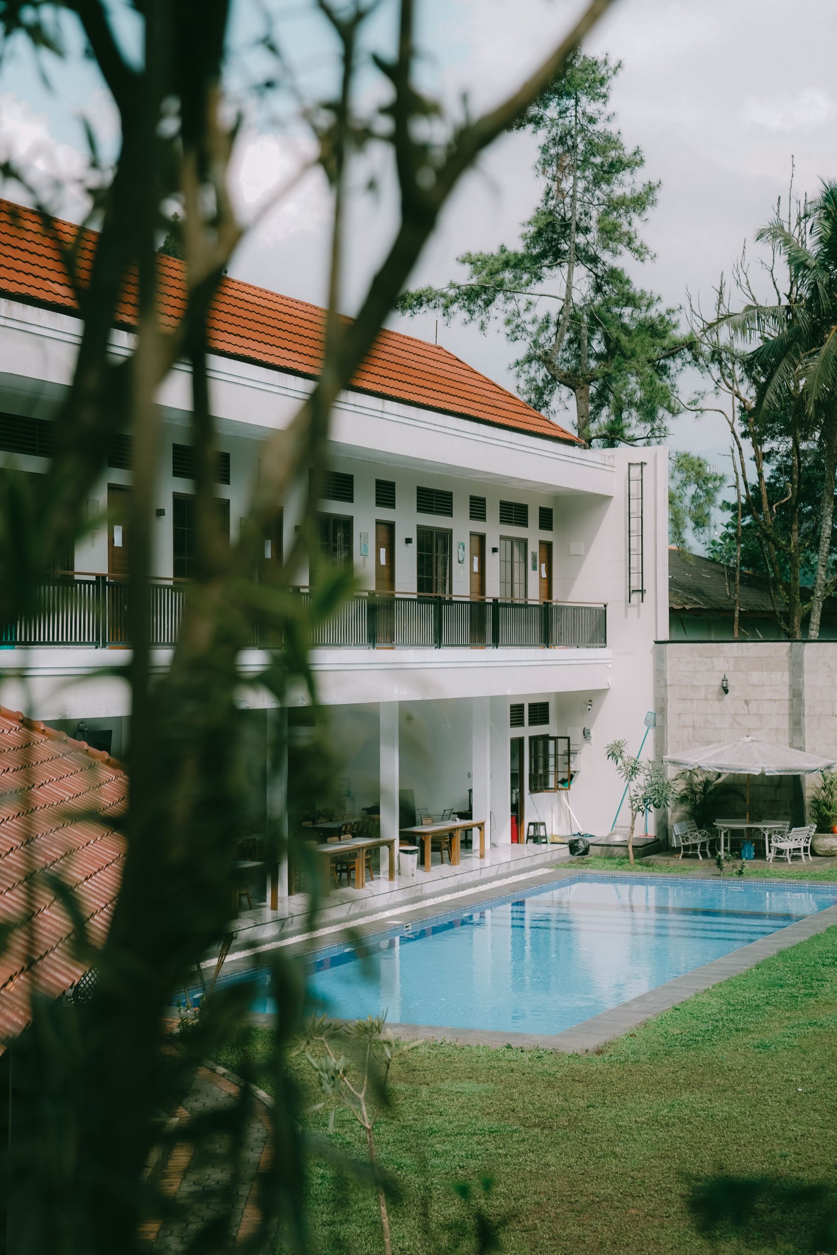 Stunning villa in Cisarua, West Java featuring a serene pool and lush surroundings.