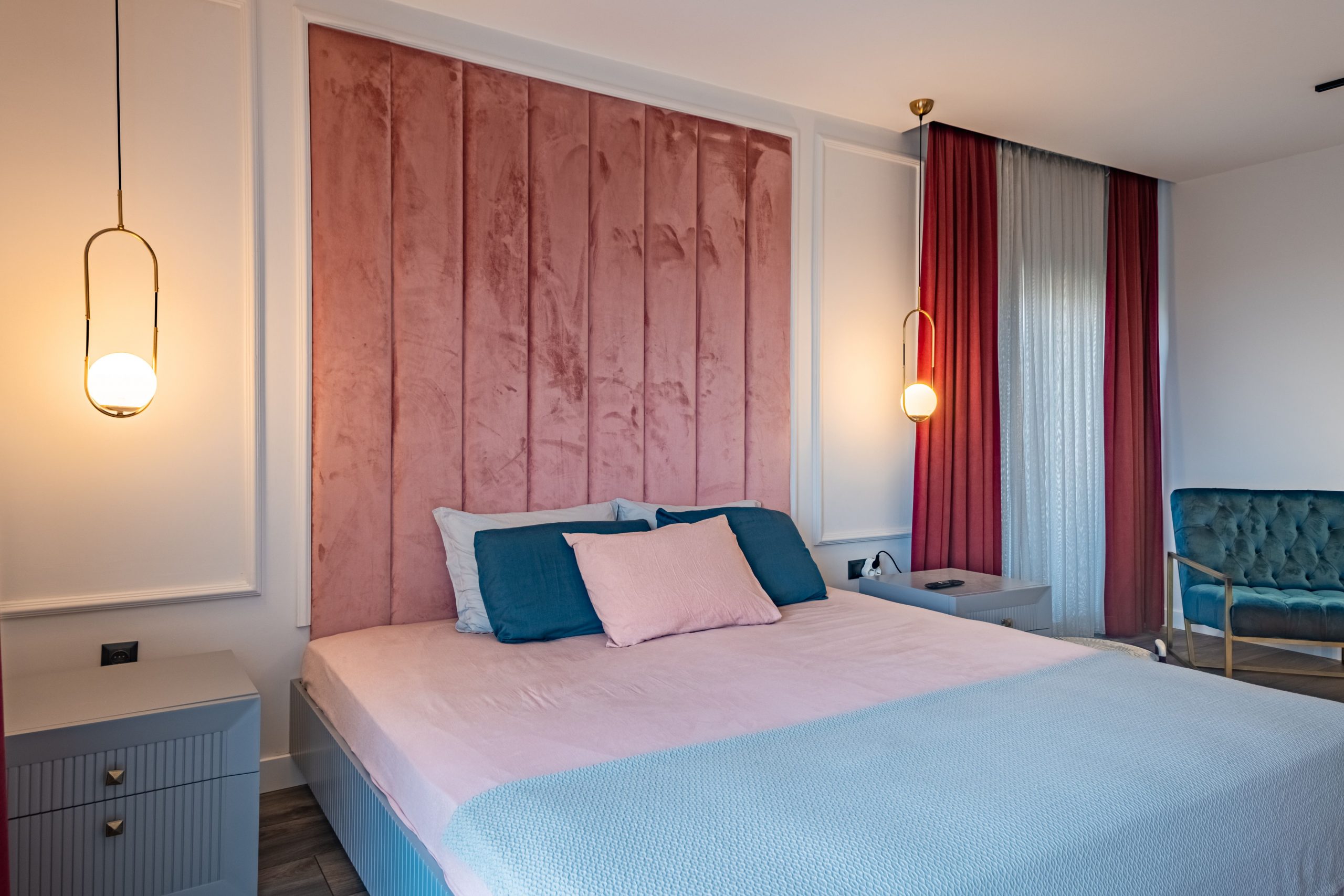 Stylish bedroom featuring modern lighting and plush velvet details, creating a cozy home interior feel.