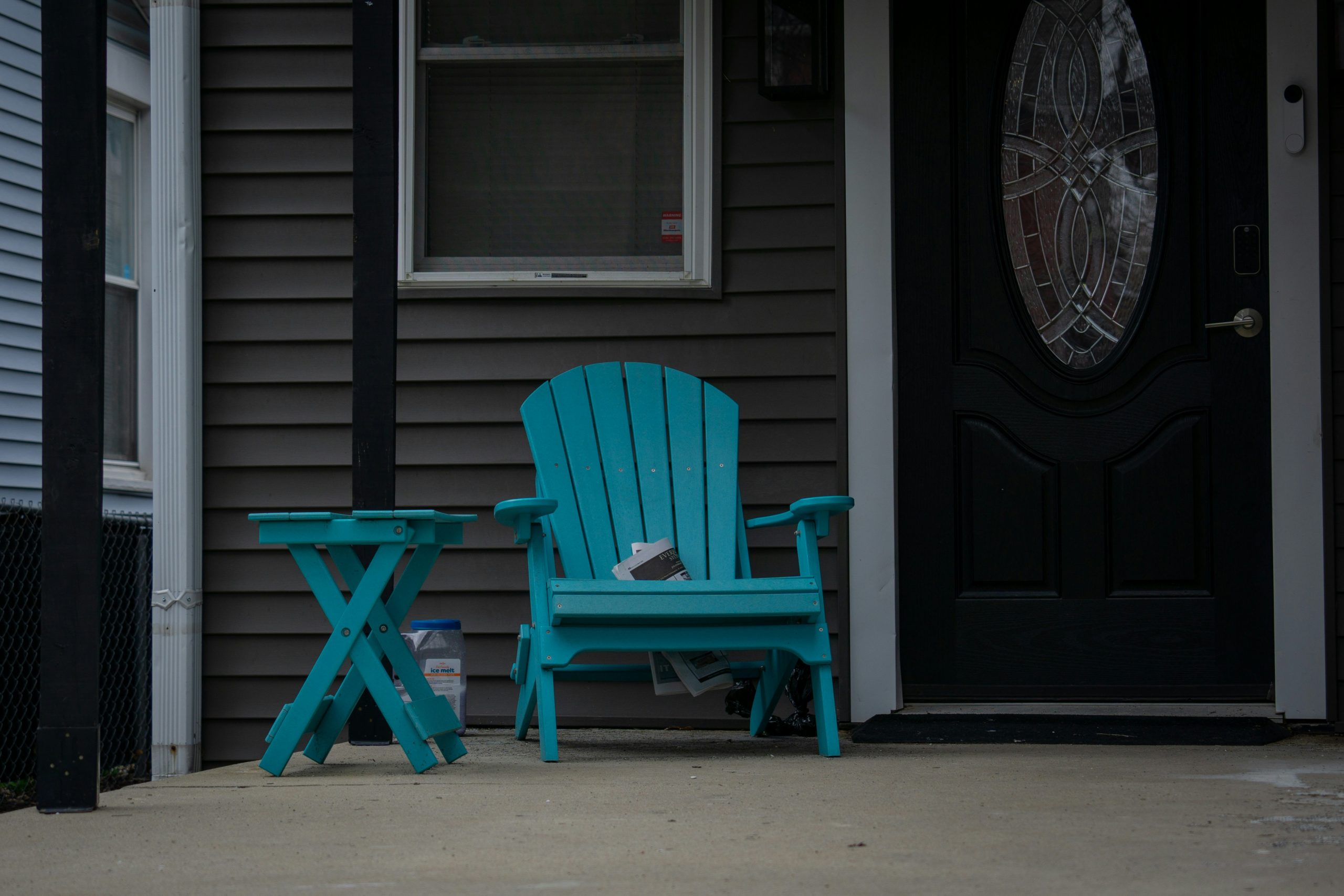 Turquoise adirondack chair and table on porch