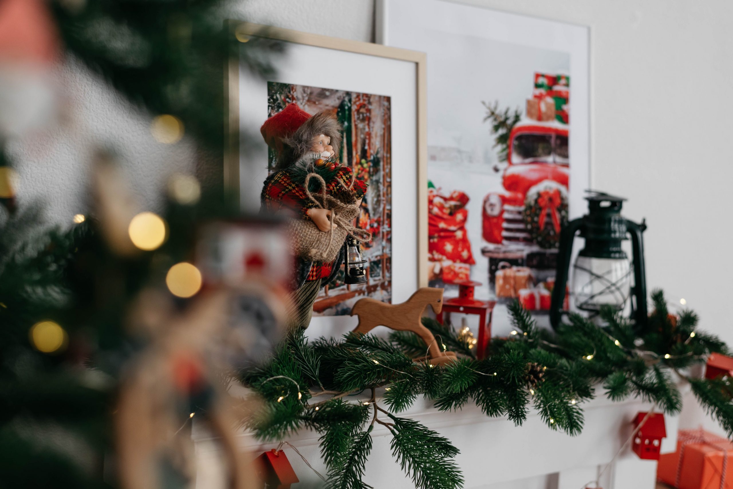 Warm and inviting Christmas mantle decoration with holiday ornaments and vintage elements.