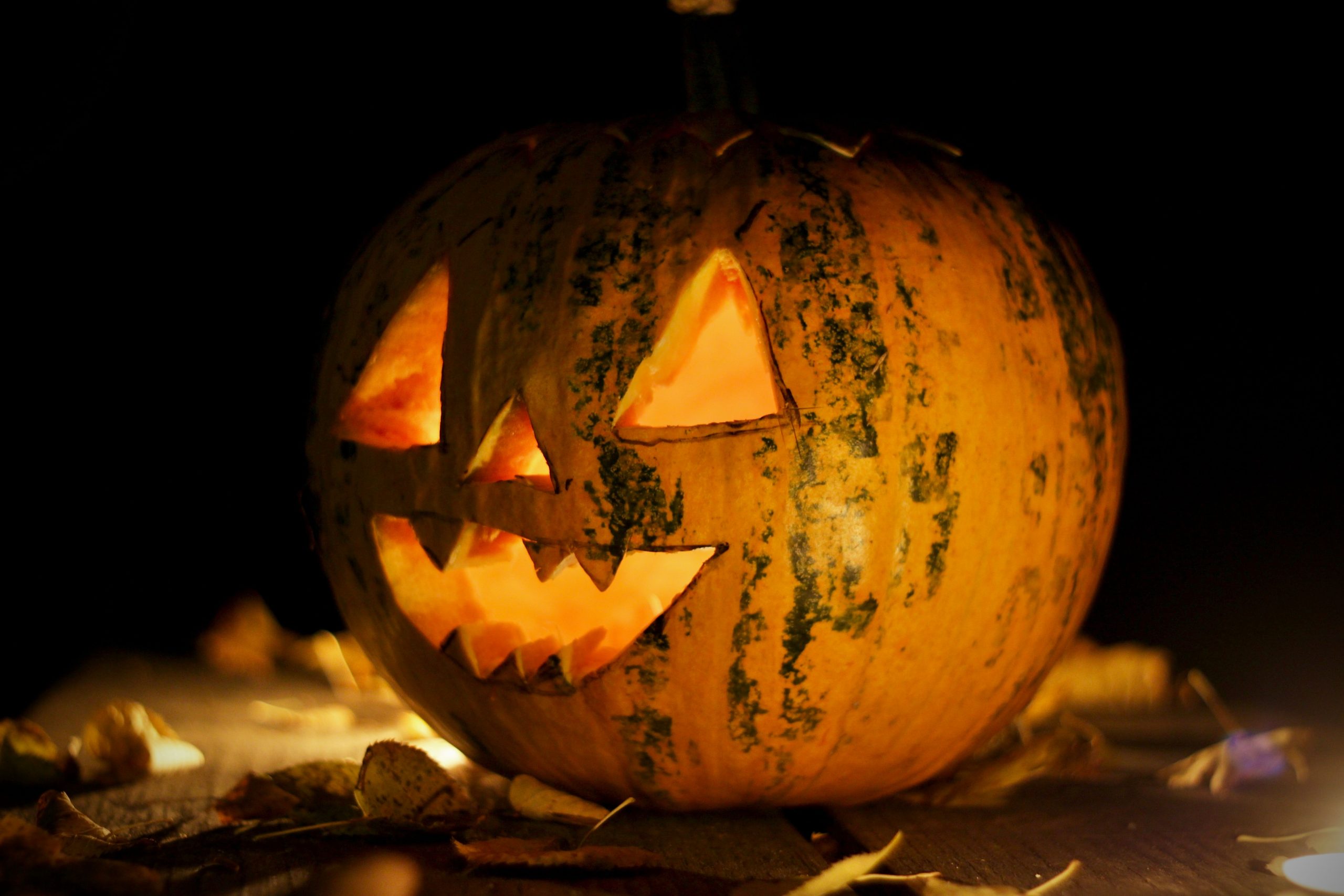 A carved and illuminated pumpkin Jack-o'-lantern creating a spooky Halloween atmosphere in Hungary.