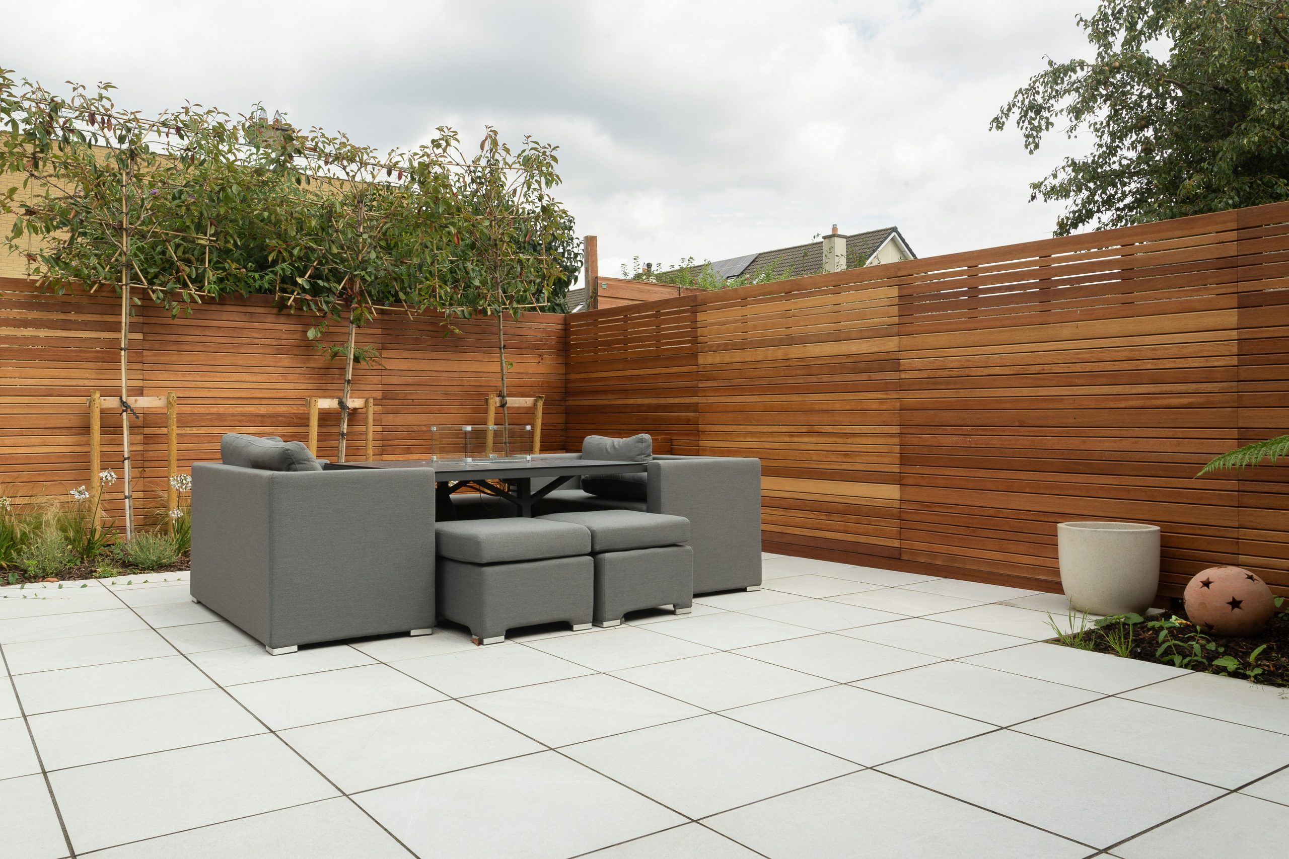 a patio with a couch and a table and chairs