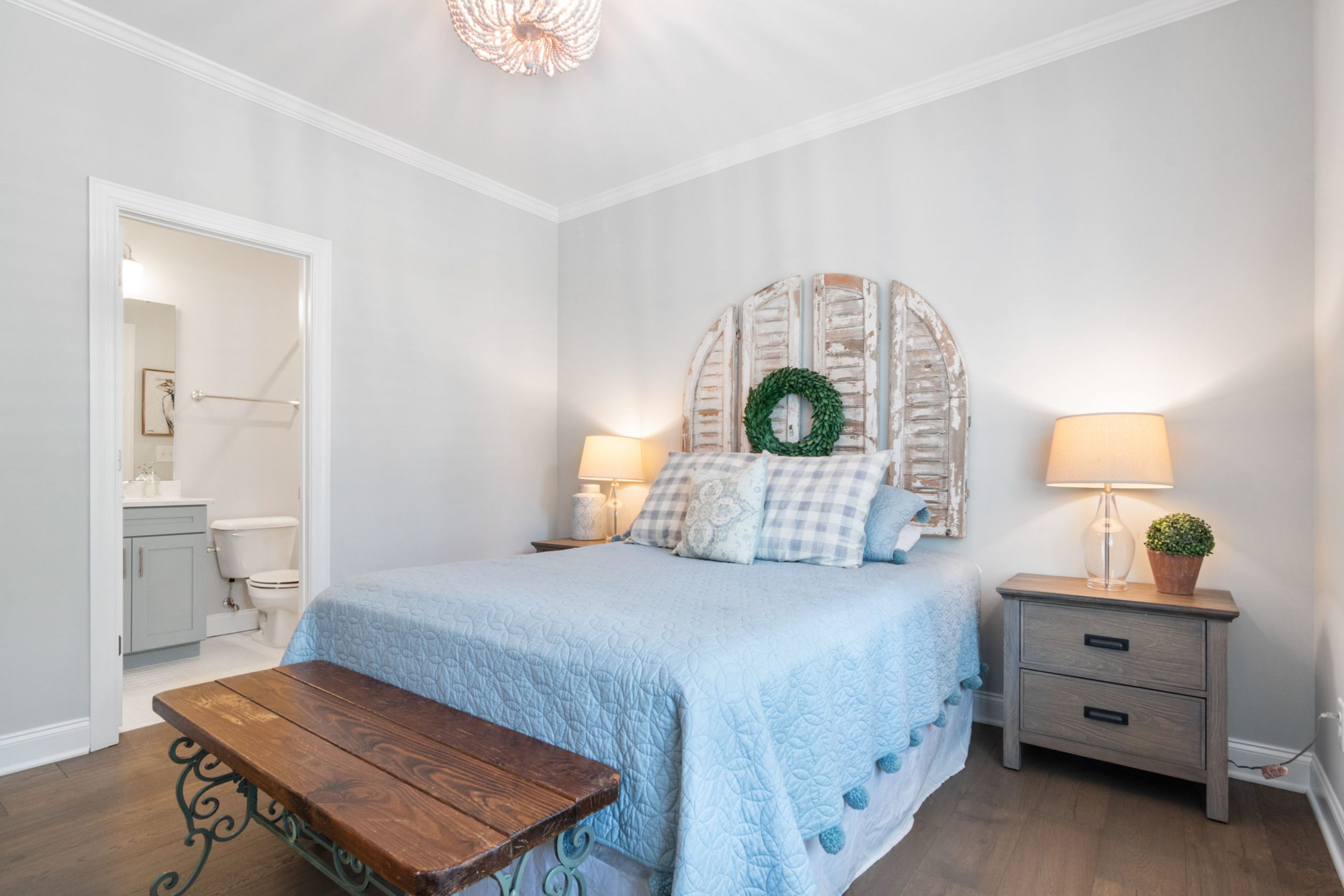 Bright and inviting bedroom with rustic decor and soft lighting, perfect for relaxation.