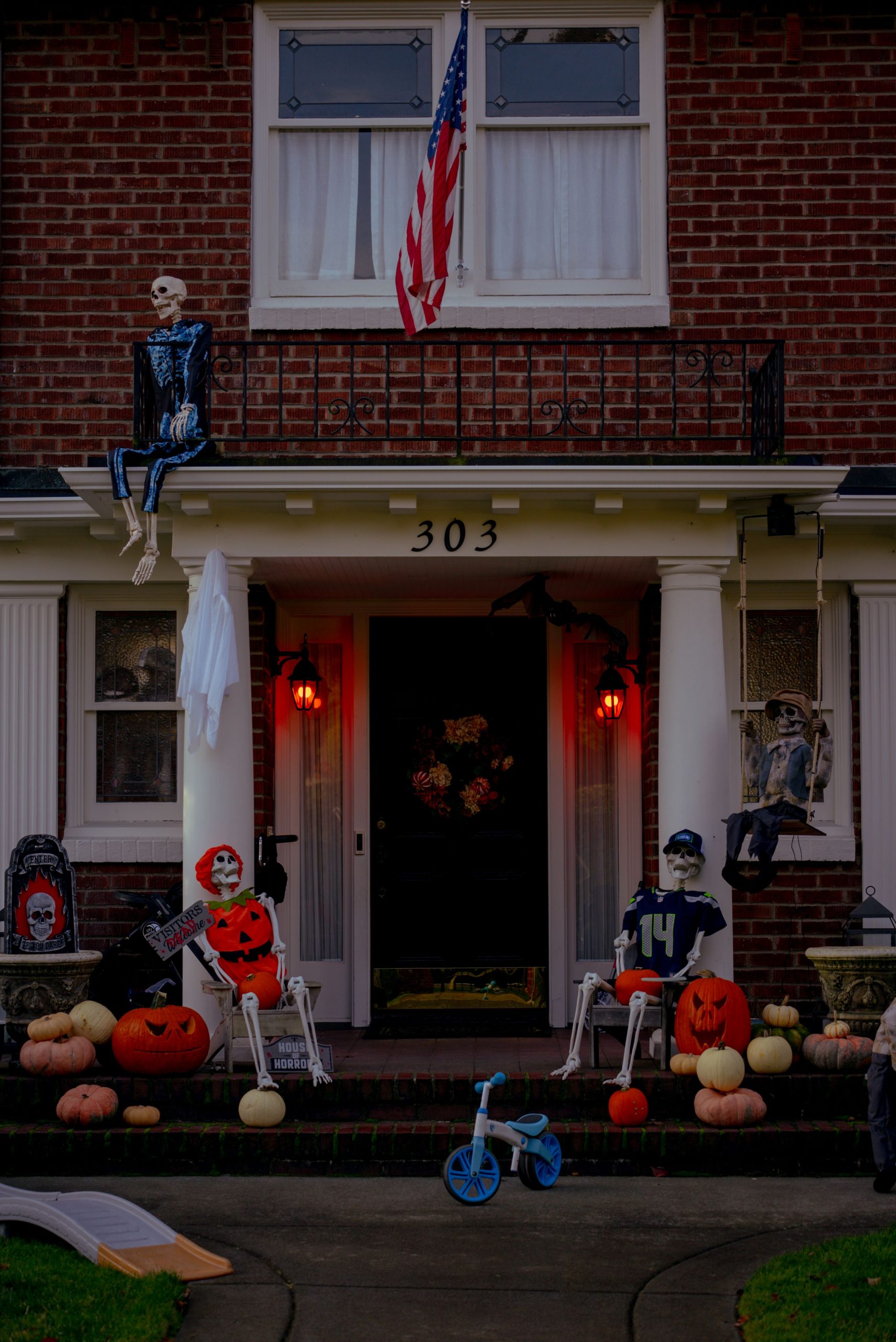 Charming Seattle home with Halloween decorations, featuring skeletons and pumpkins on the porch.