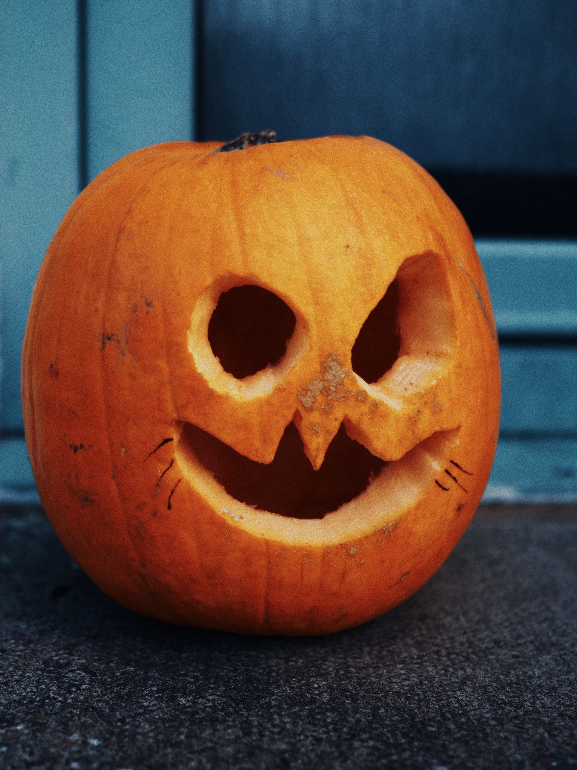 Close-up of a spooky carved pumpkin lantern for Halloween decor.
