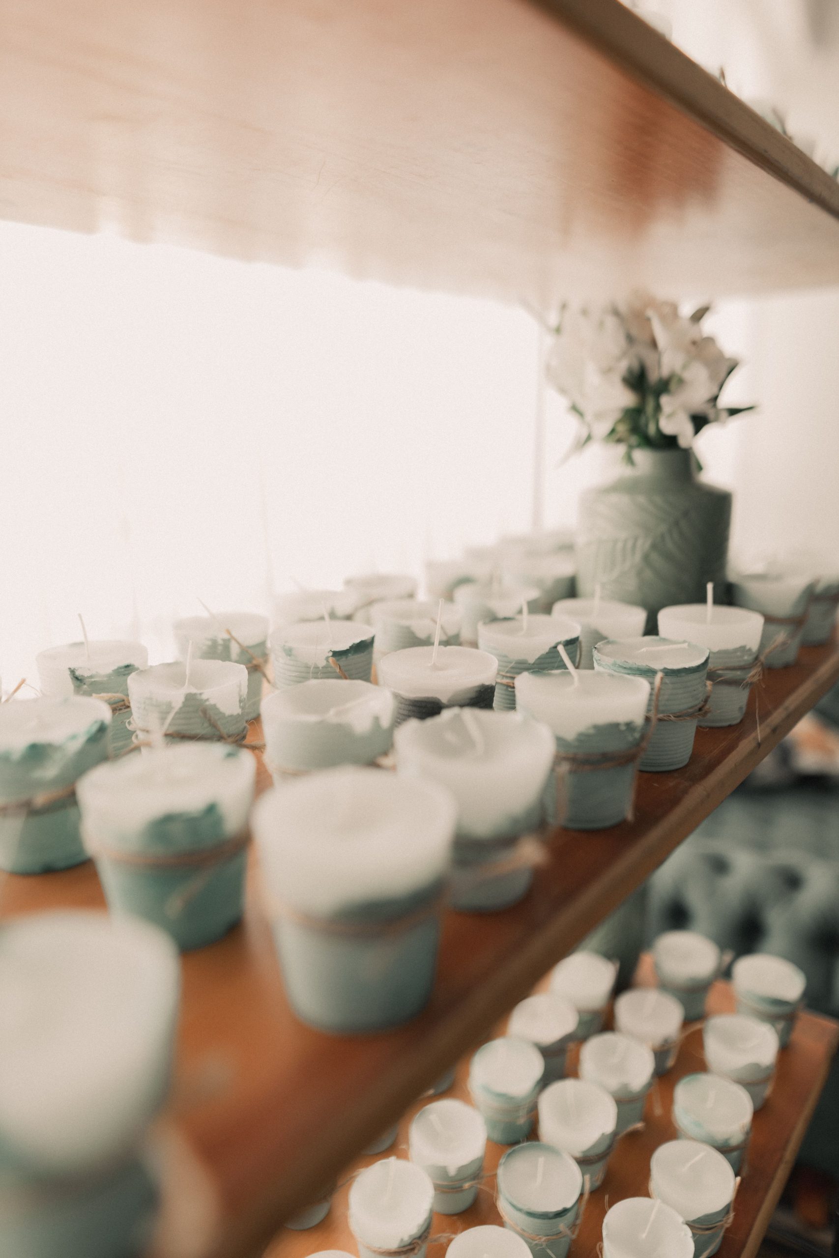 Cozy indoor display of ceramic candles on shelves with soft lighting.