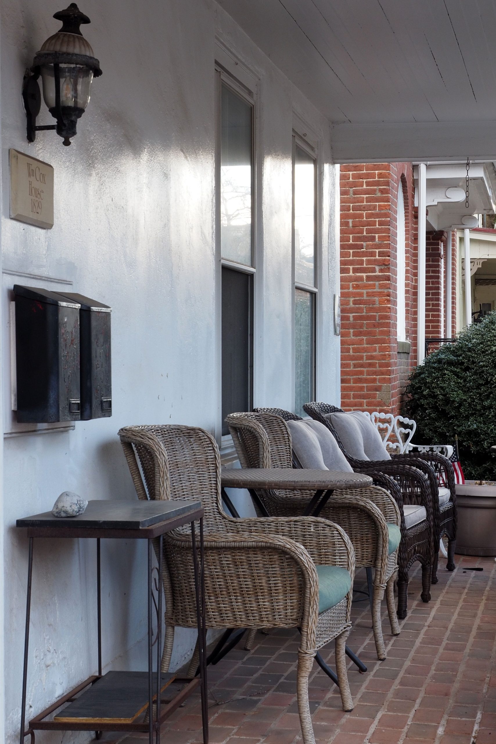 Cozy seating arrangement on a porch with wicker chairs in Doylestown, Pennsylvania.