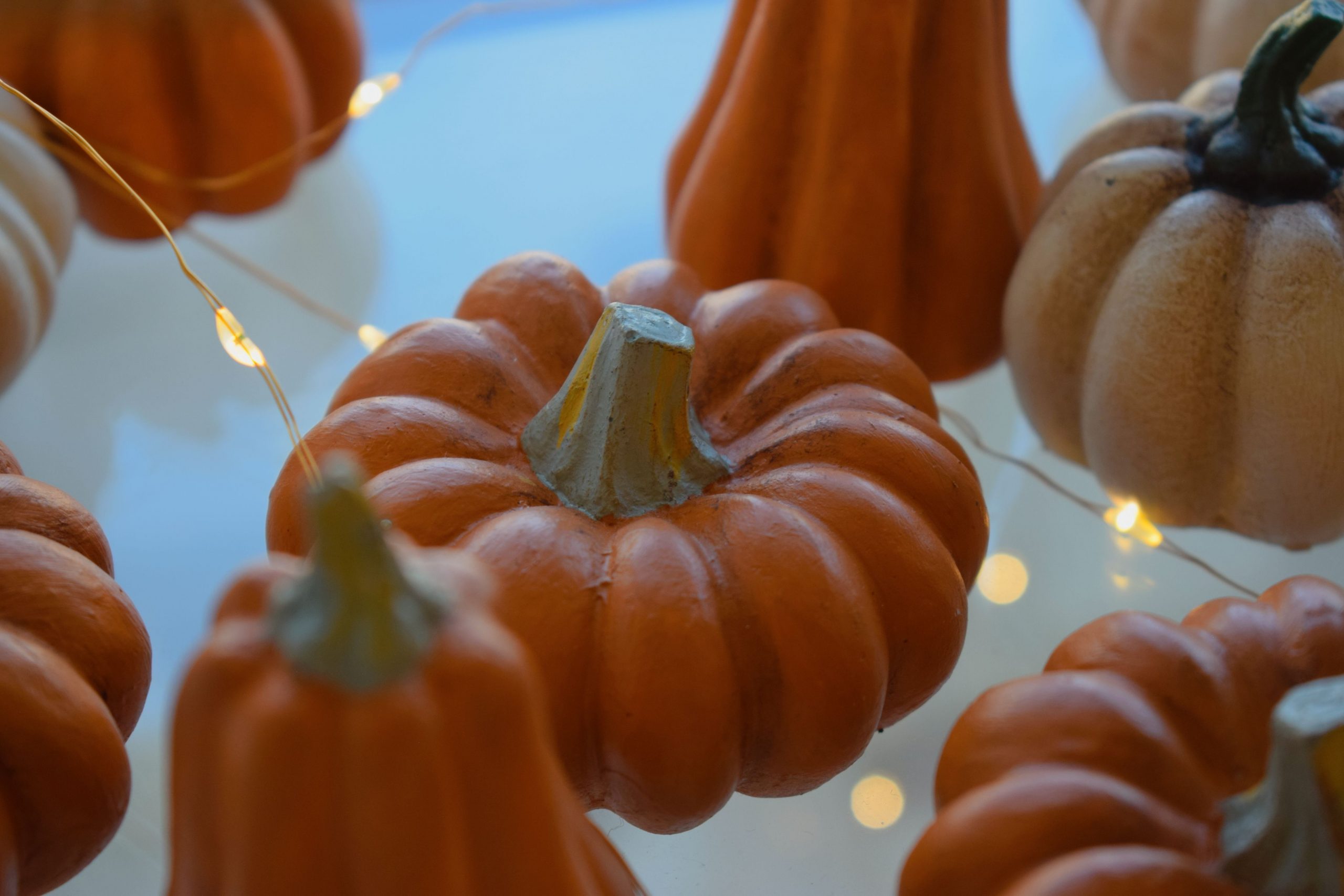Decorative pumpkins adorned with string lights perfect for autumn and Halloween settings.