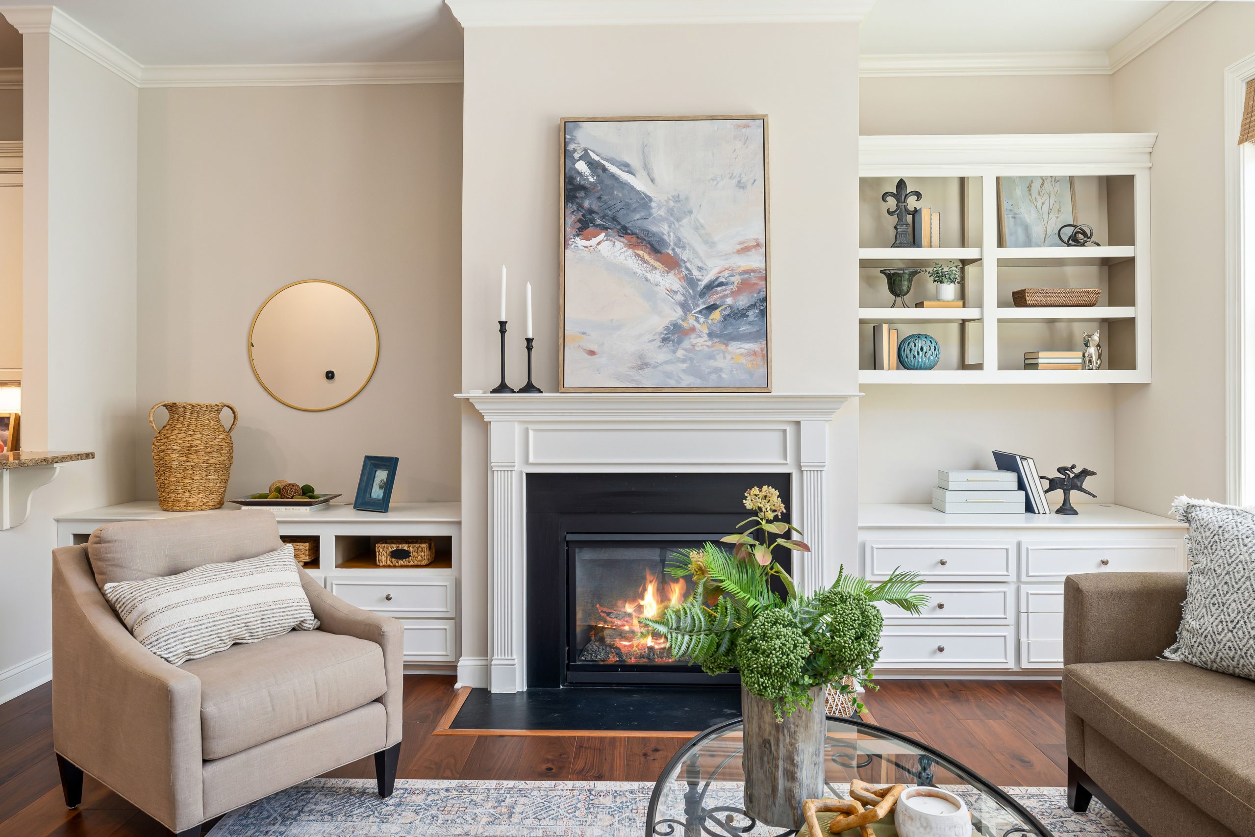 Elegant living room featuring a modern fireplace, art, and stylish furniture for a cozy ambiance.