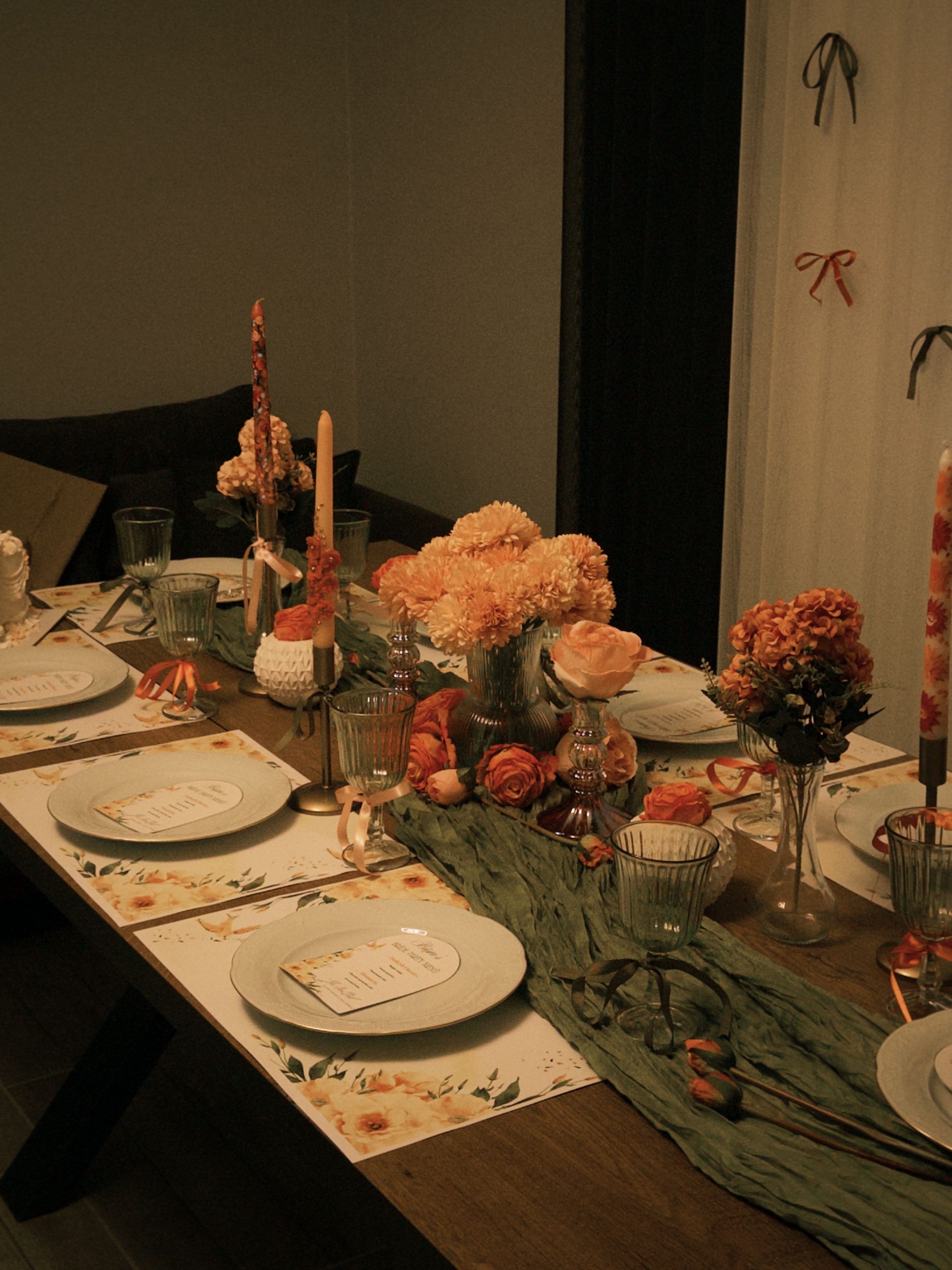 Elegant table setup with floral decorations and candles, perfect for a cozy celebration.