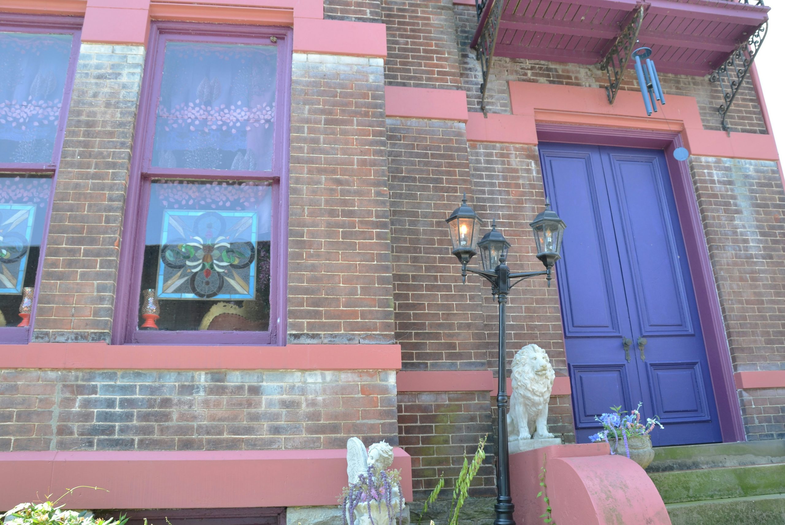 Historic brick home with multi-colored trim and door