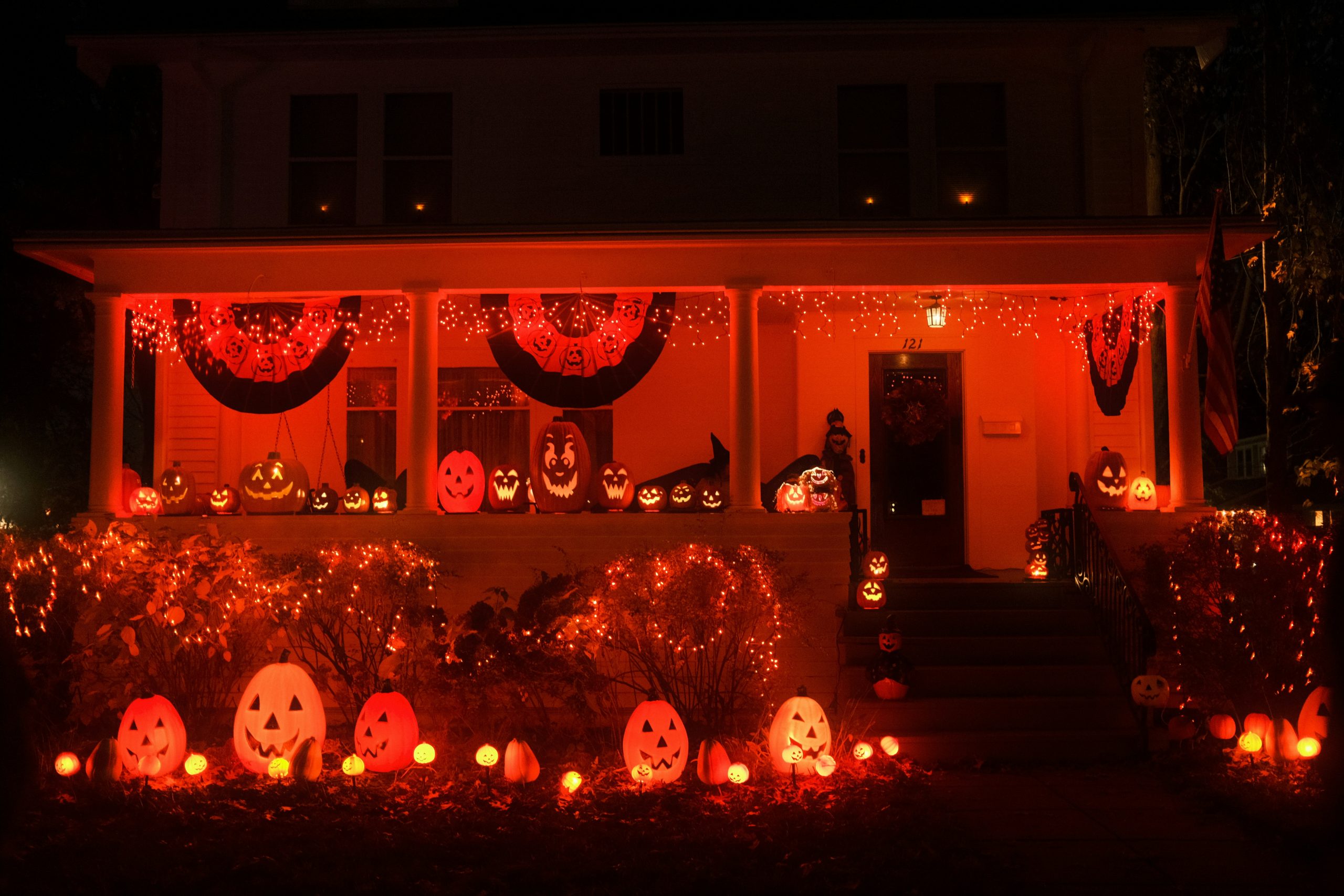 House decorated for halloween with orange lights and pumpkins
