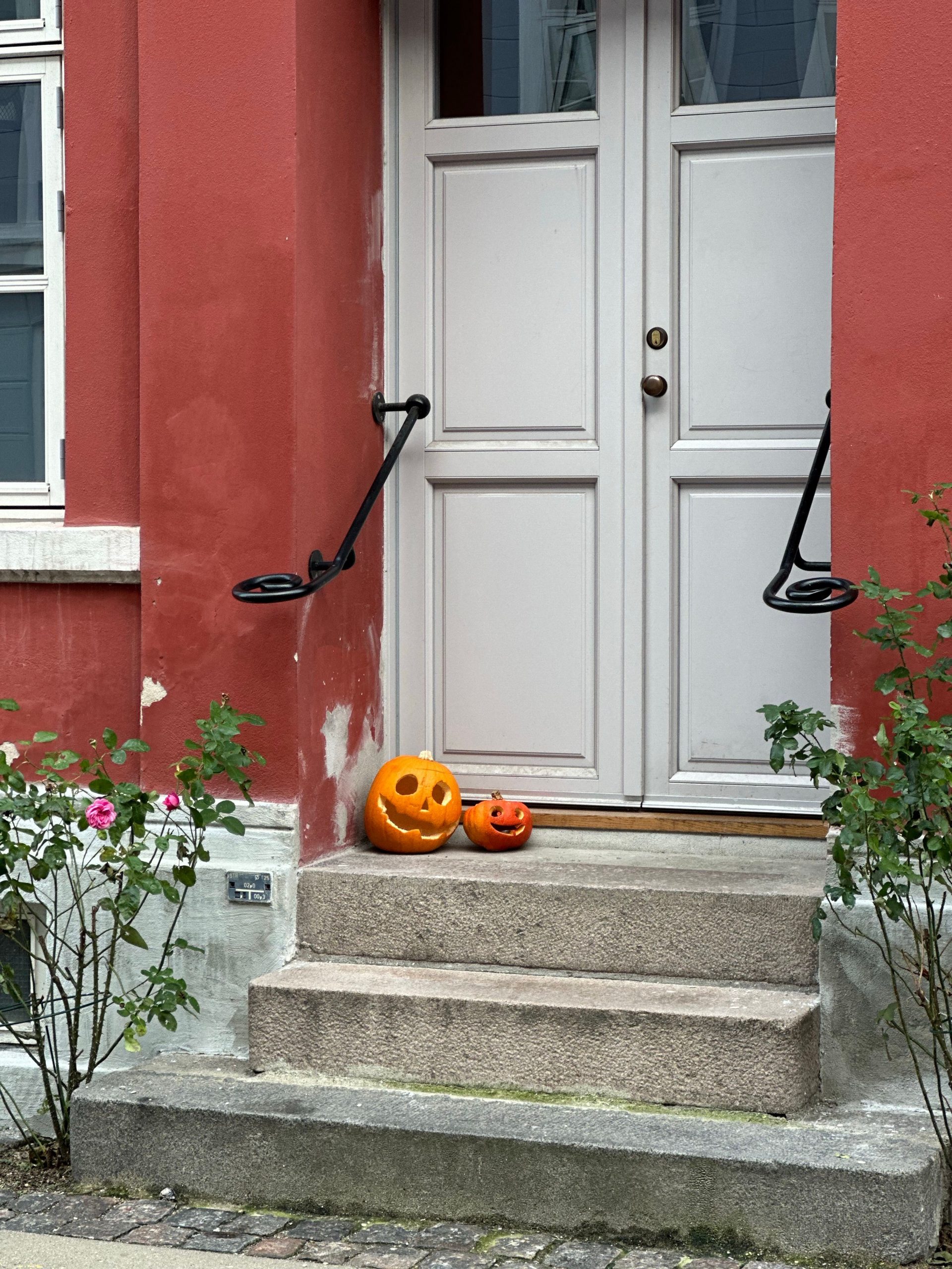 Jack-o'-lanterns on stone steps embody the Halloween spirit in Copenhagen, Denmark.