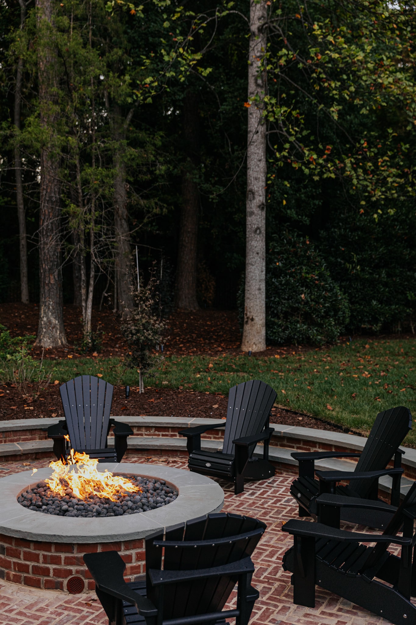 Our Sunken Fire Pit Paired With Black Adirondack Chairs
