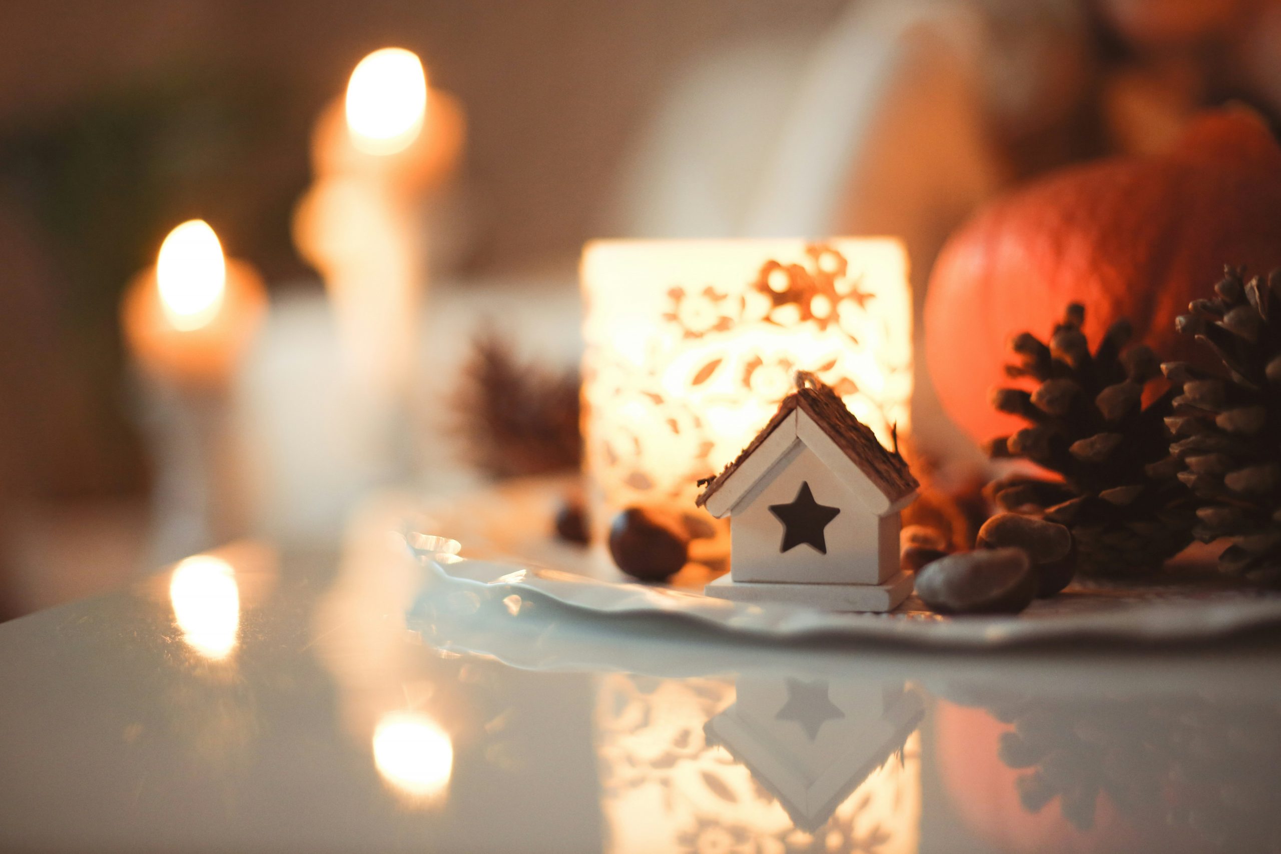 Some decorations at my home for autumn and winter with candles, a pumpkin, chestnuts and pegs.