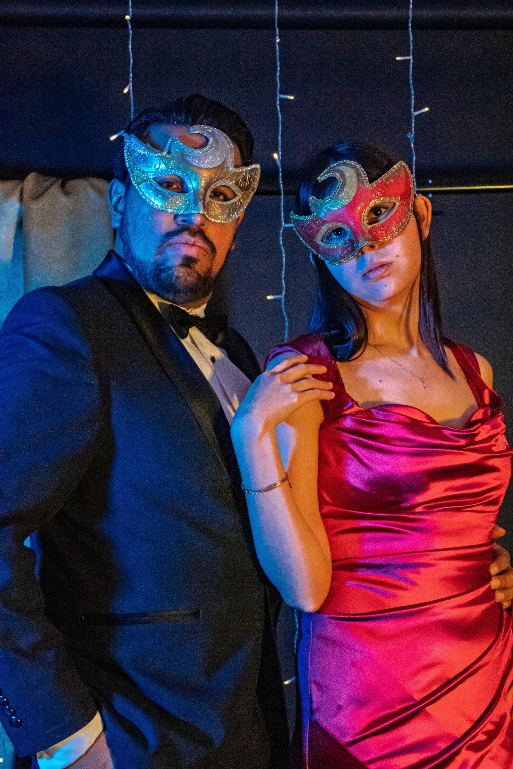 Sophisticated couple in masks at a Mexico City masquerade ball, showcasing elegance and style.