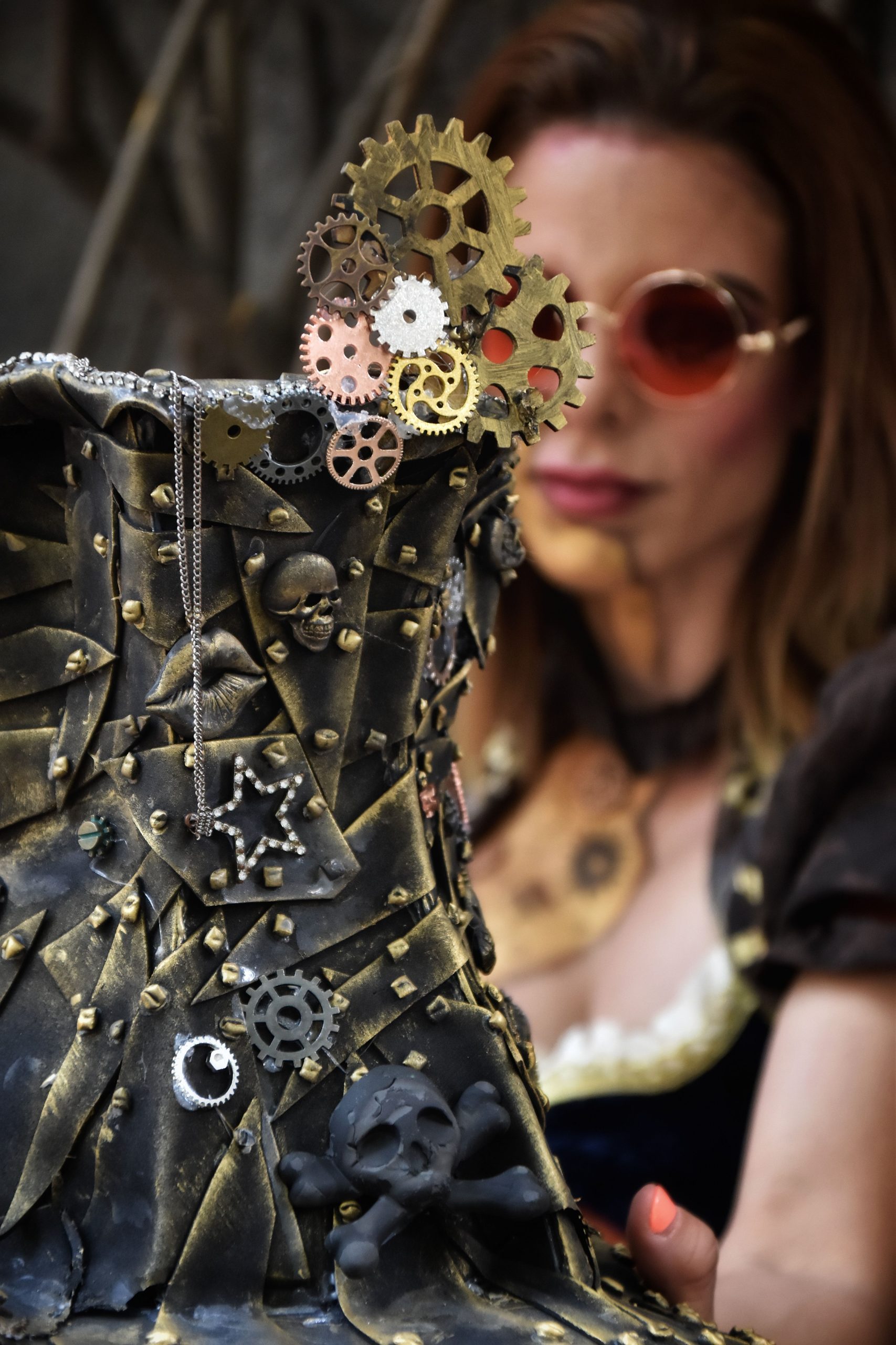 Steampunk-themed woman's portrait with gear-adorned boot, highlighting unique fashion.