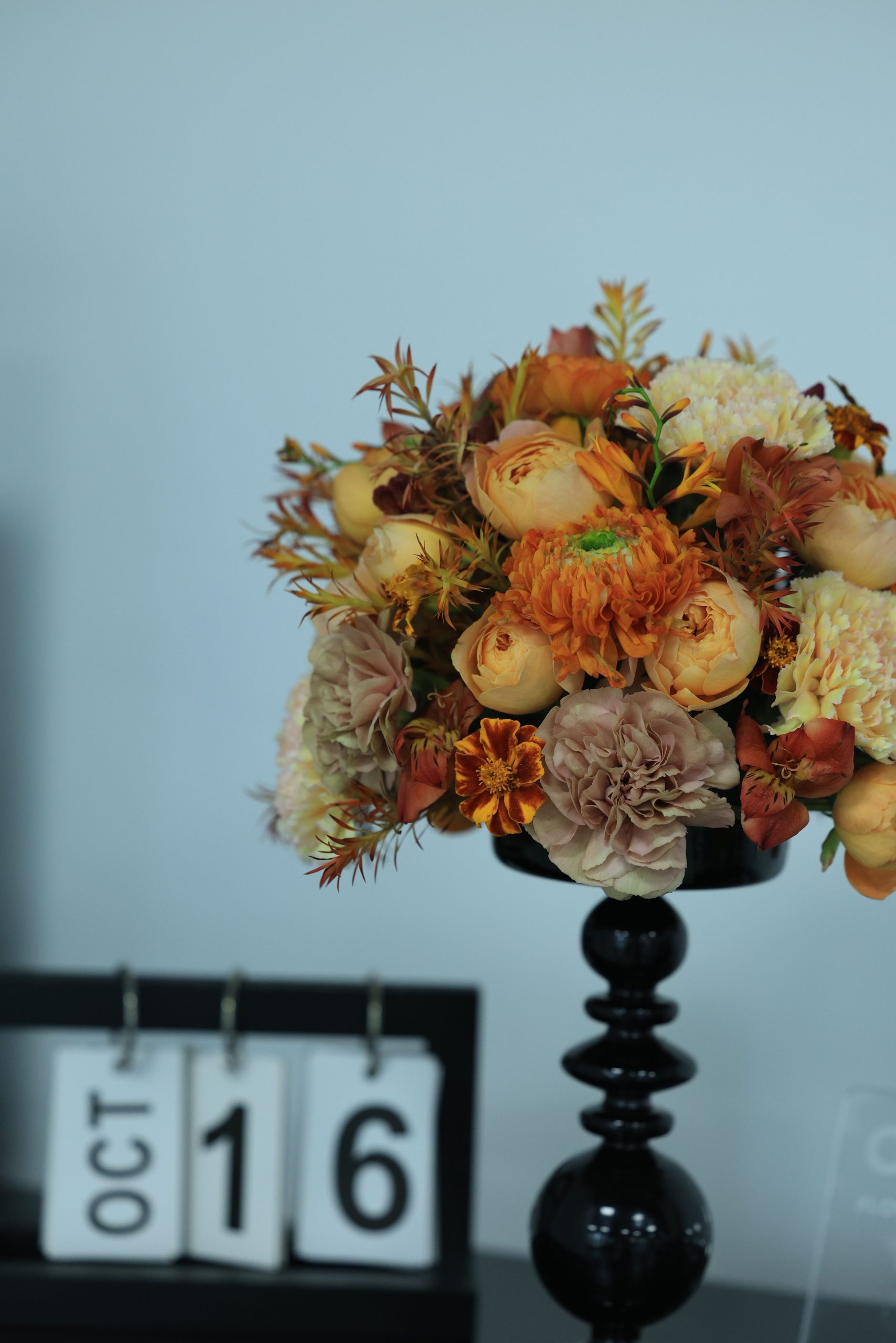 Stylish bouquet in fall colors with October 16 date board.