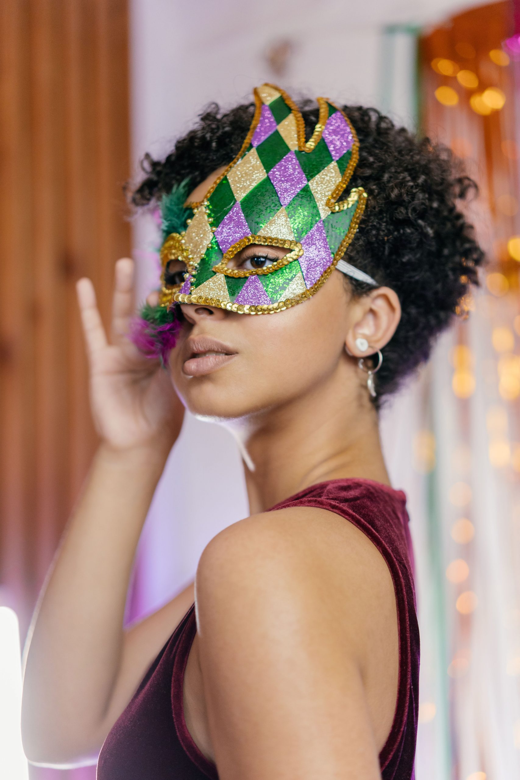 Stylish portrait of a woman in a vibrant masquerade mask, ideal for party and fashion themes.