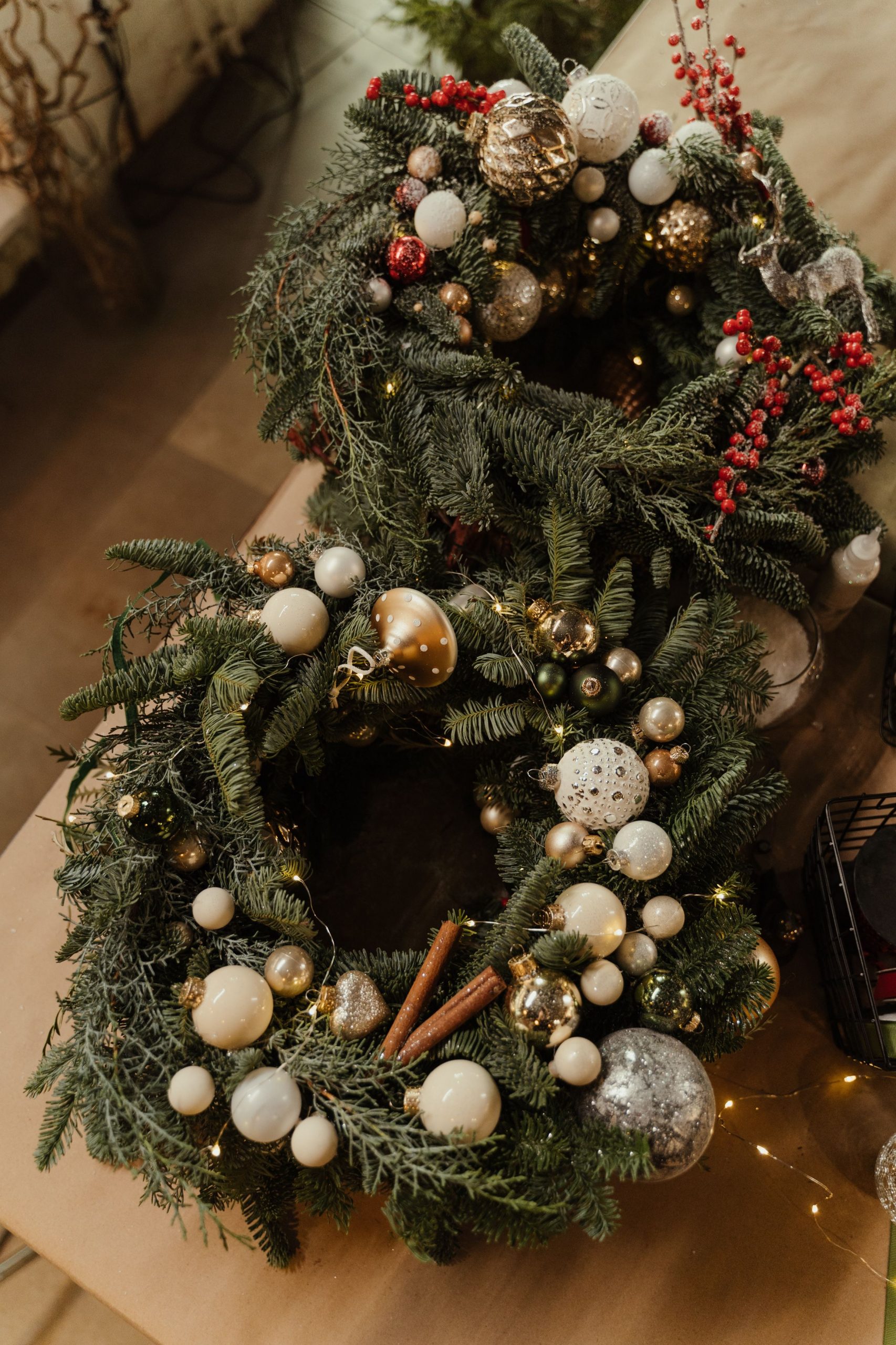 Two beautifully decorated Christmas wreaths with baubles and ornaments, perfect for festive indoor decoration.