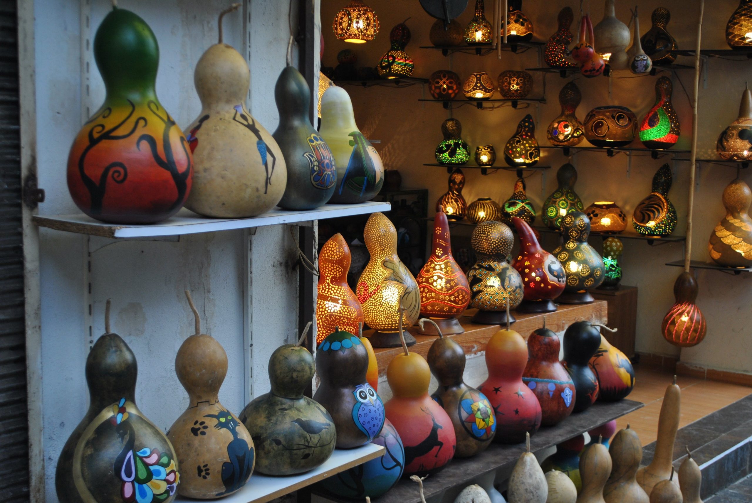 Vibrant display of hand-painted and illuminated gourds in an artisan shop.