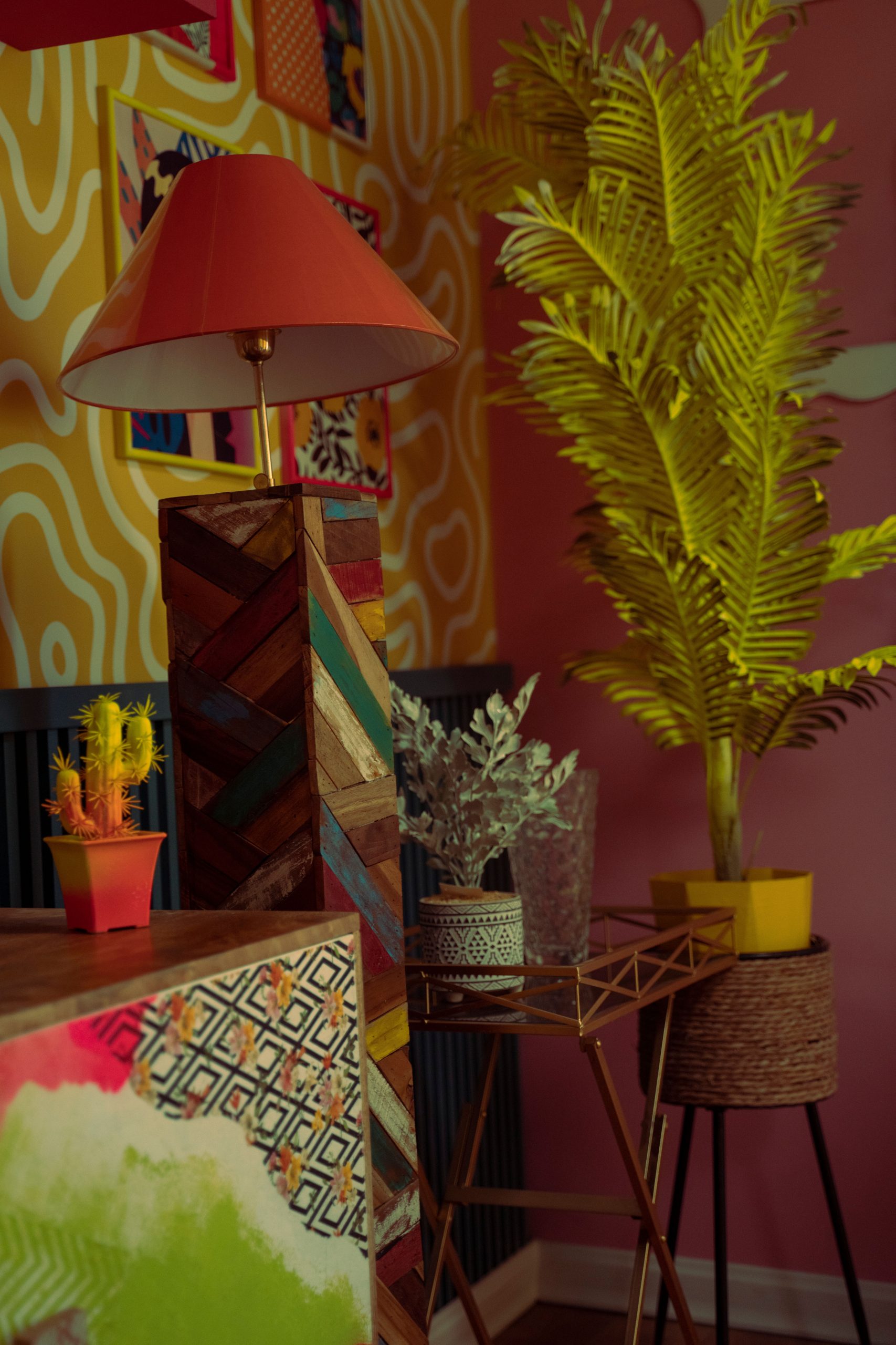 Vibrant retro-themed interior showcasing colorful furniture, decor, and lush plants.