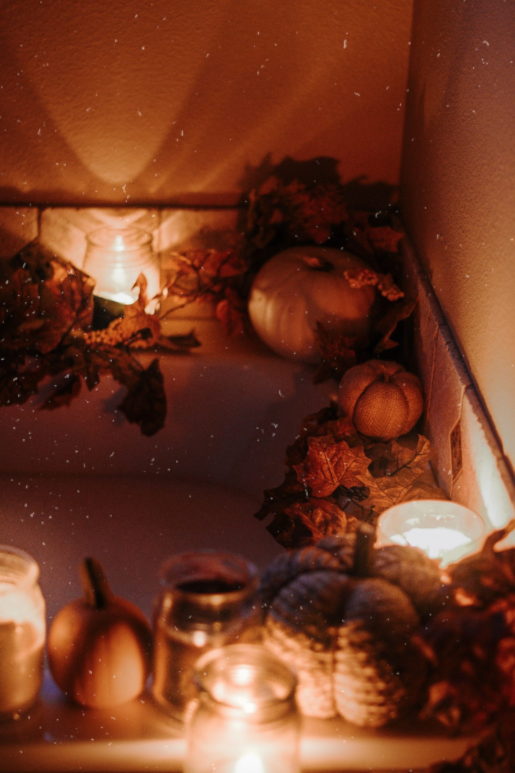 Warm and intimate bathroom setup with candles and autumn decor.