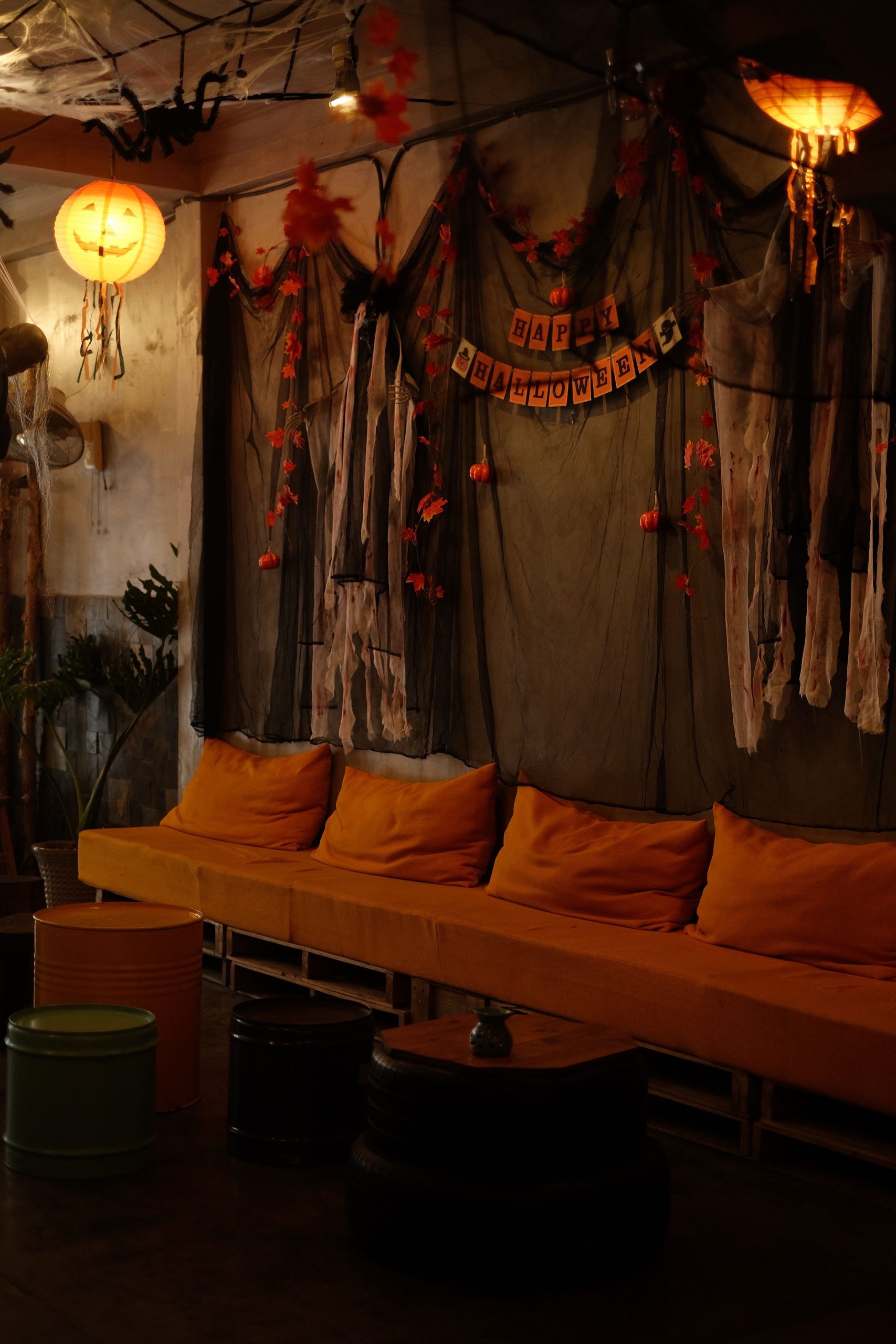 Warm and inviting Halloween-themed lounge with festive decorations and cozy seating.