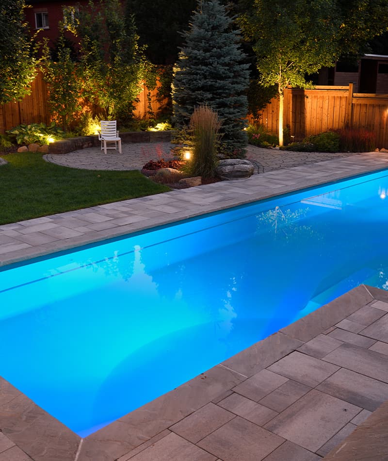 How Pool Features Like Waterfalls, Lighting & Seating Can Transform Your Backyard