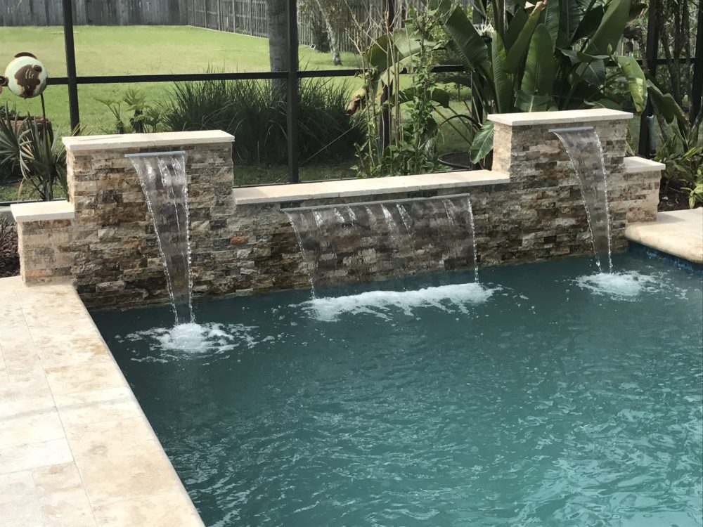 Travertine stack stone wall and waterfalls - Crystal Pools and Spas